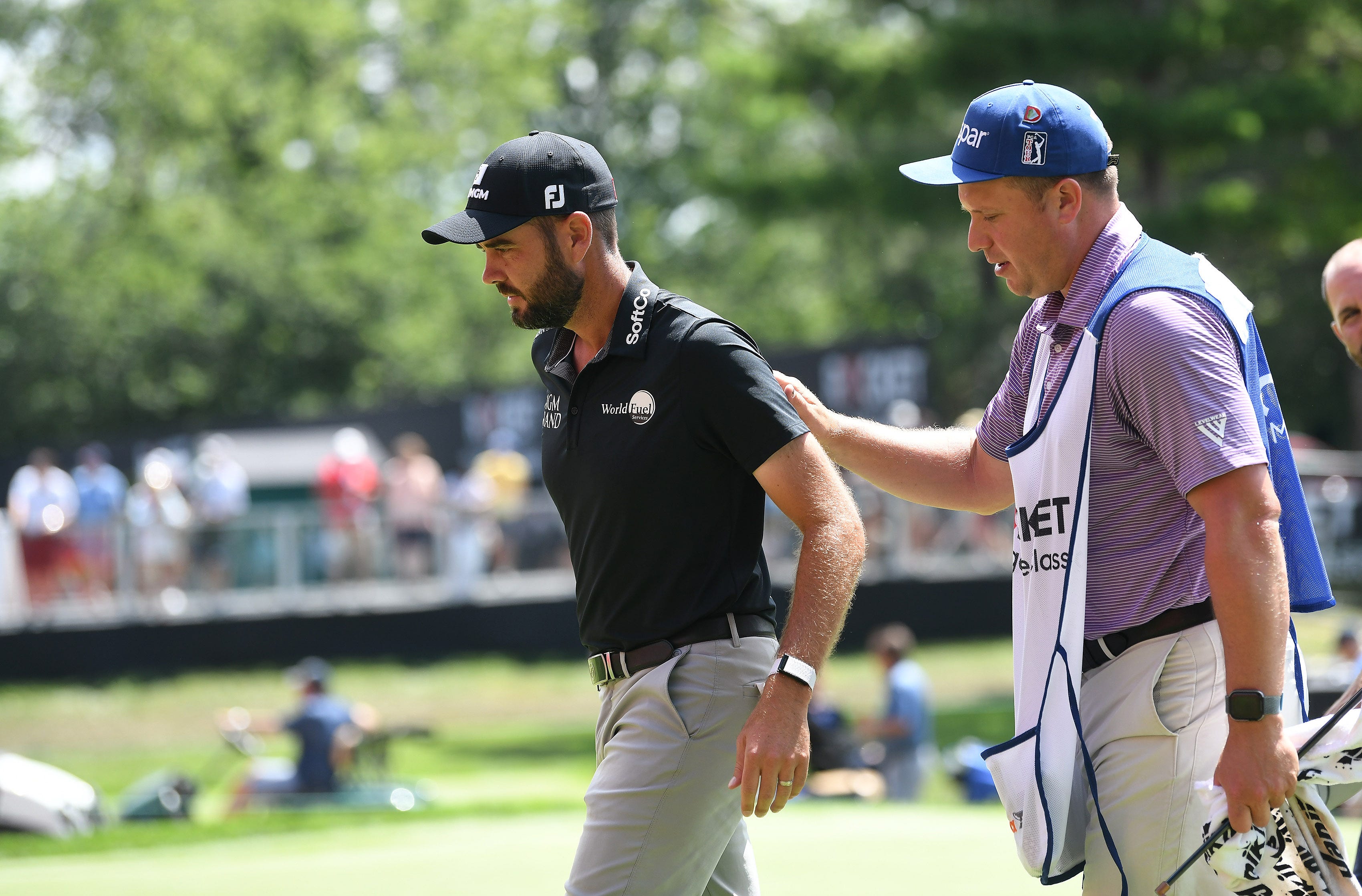 Troy Merritt gets a pat on the back from his caddie after finishing Round 2.