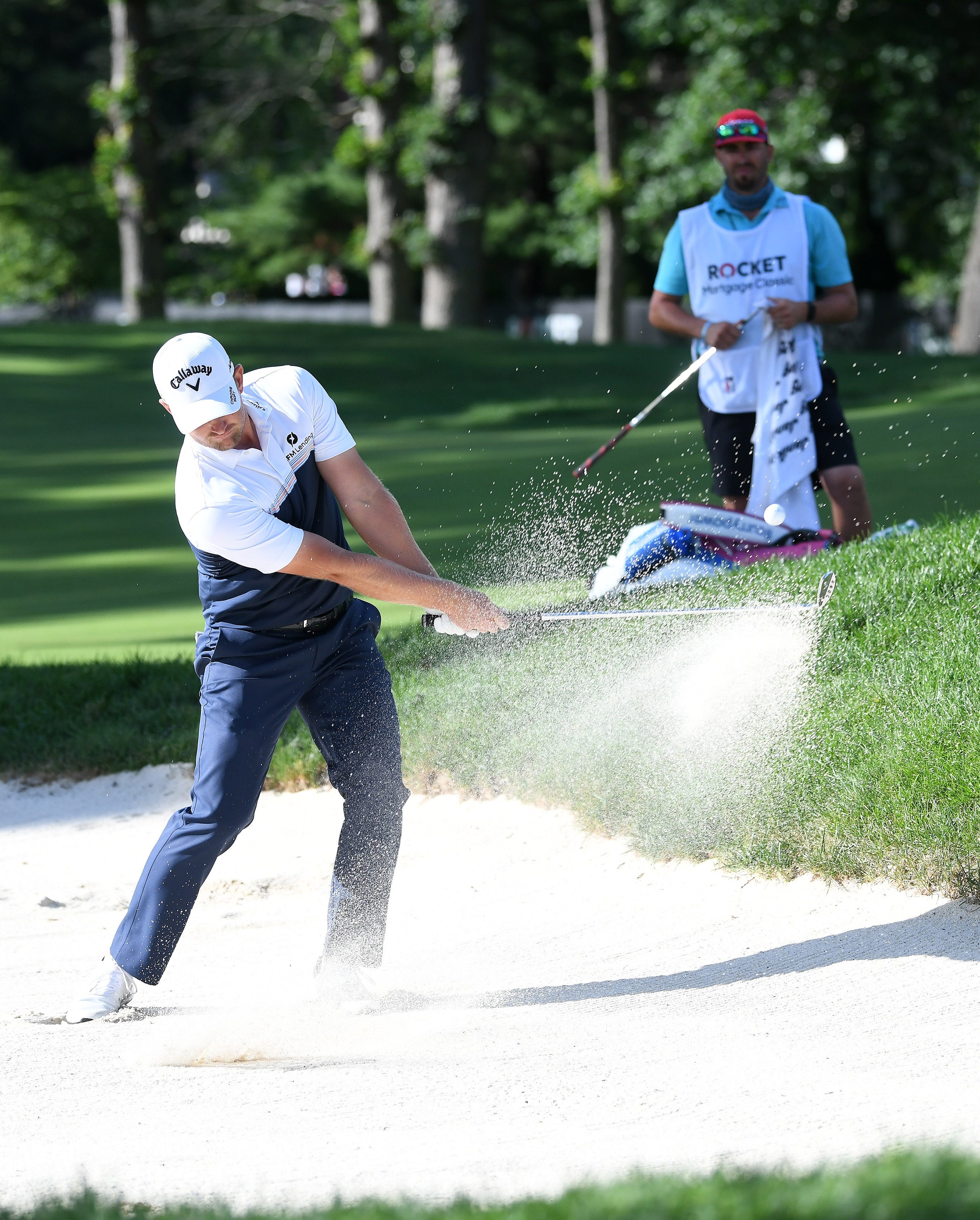 Tom Lewis hits out of the sand trap on hole No. 9.