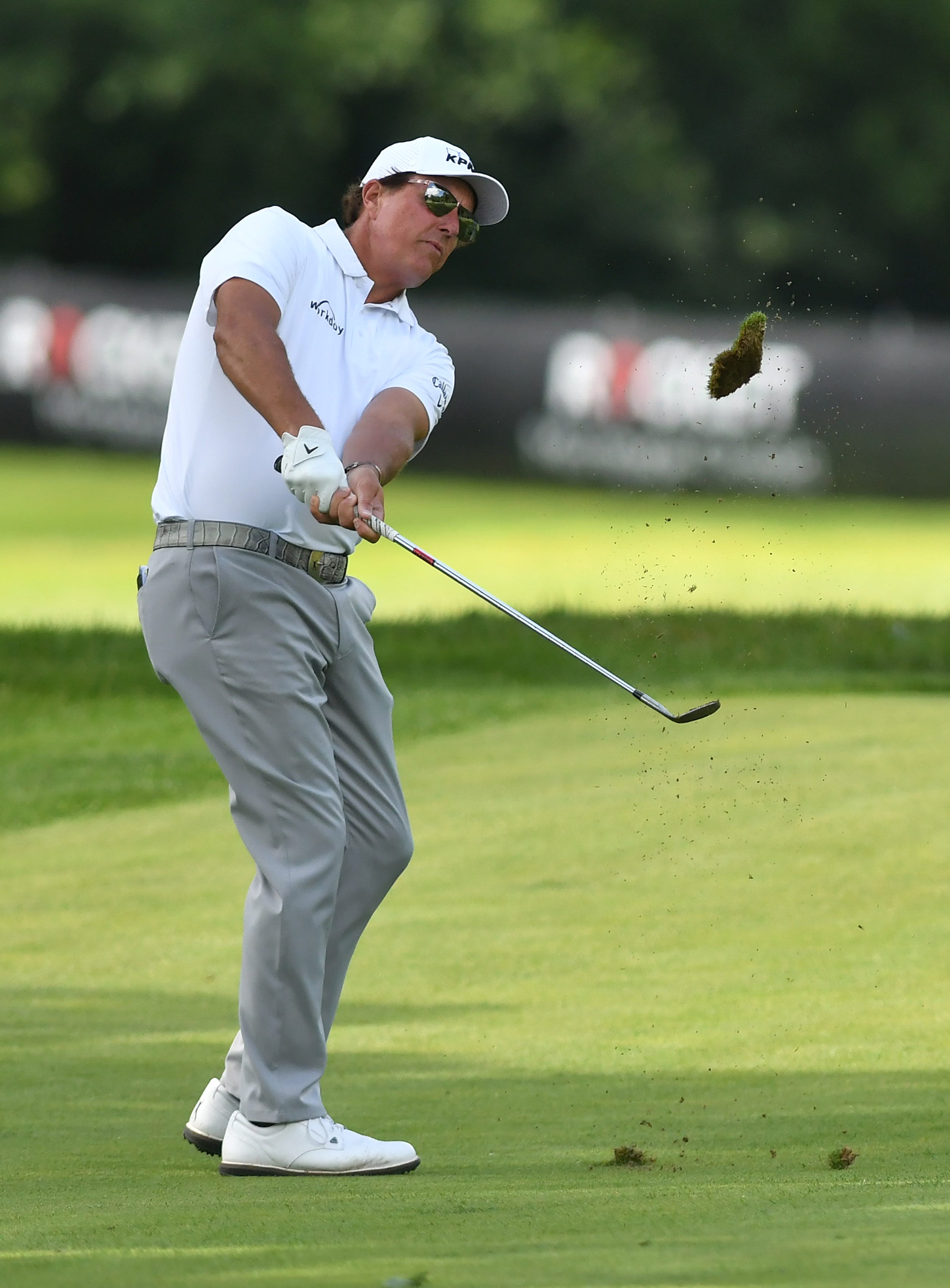 Phil Mickelson hits a fairway shot on the eighth hole.