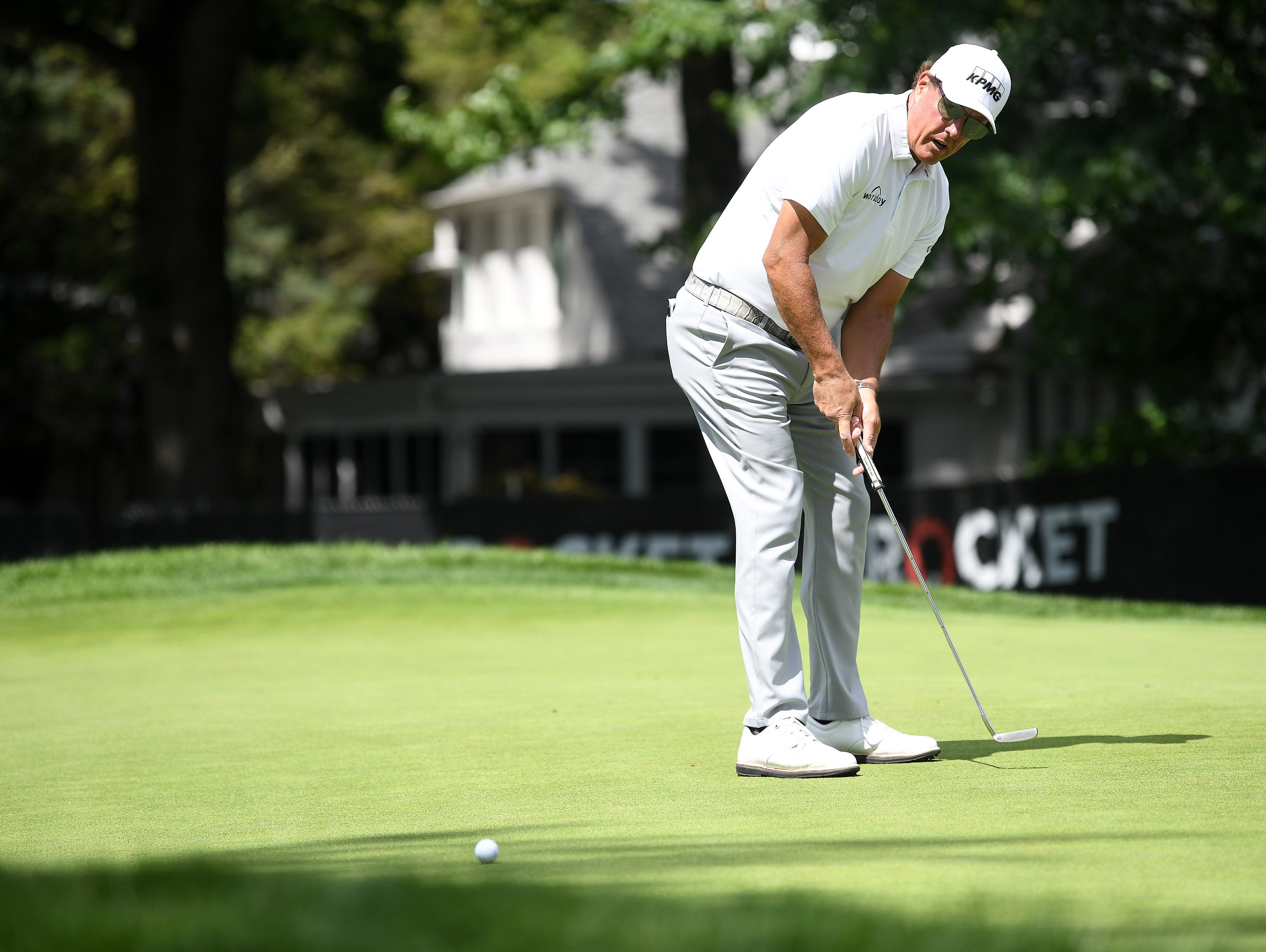 Phil Mickelson putts and barely misses on the ninth green.