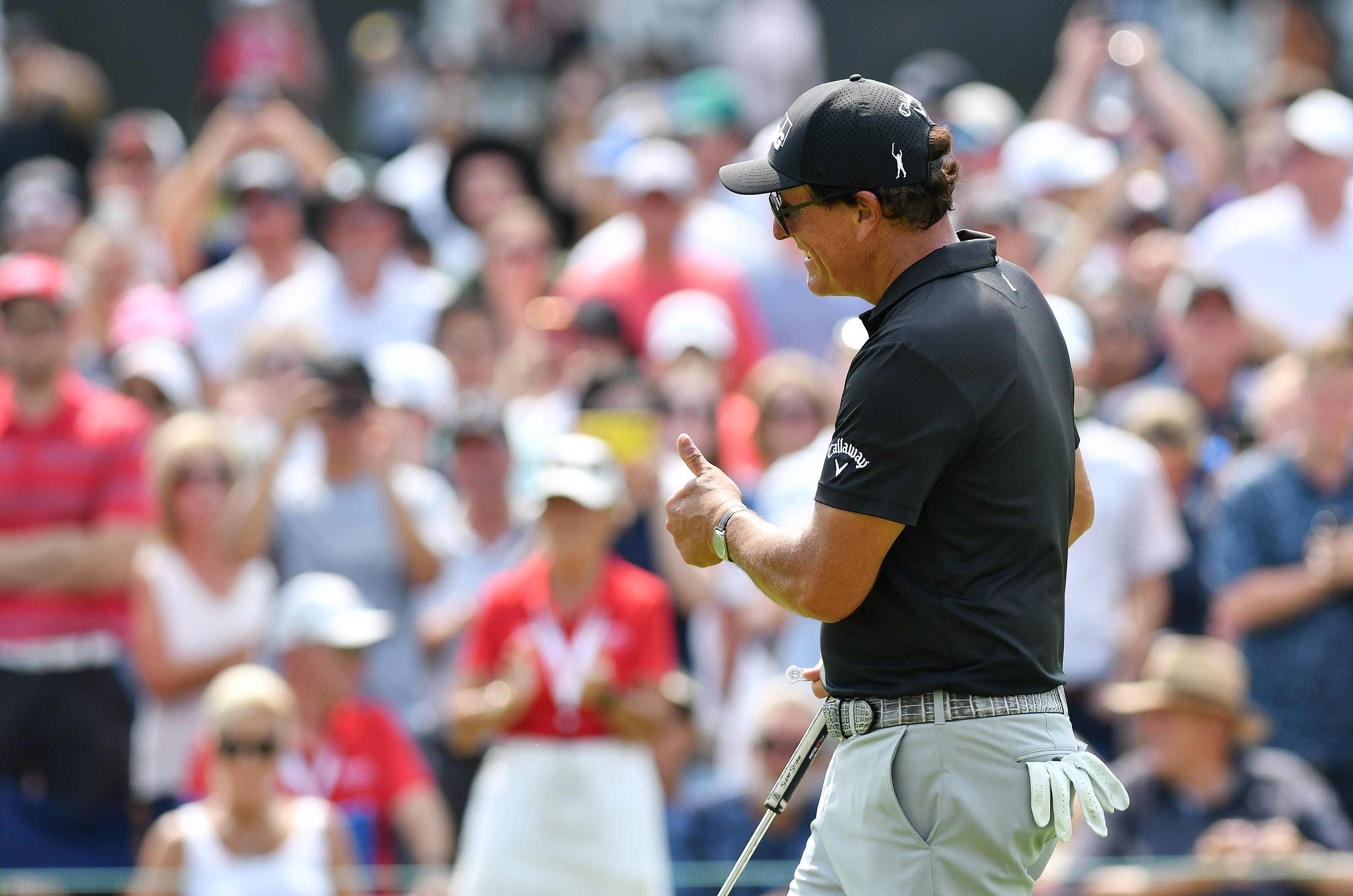 Phil Mickelson gives a thumbs-up on the 18th green at the 2021 Rocket Mortgage Classic.