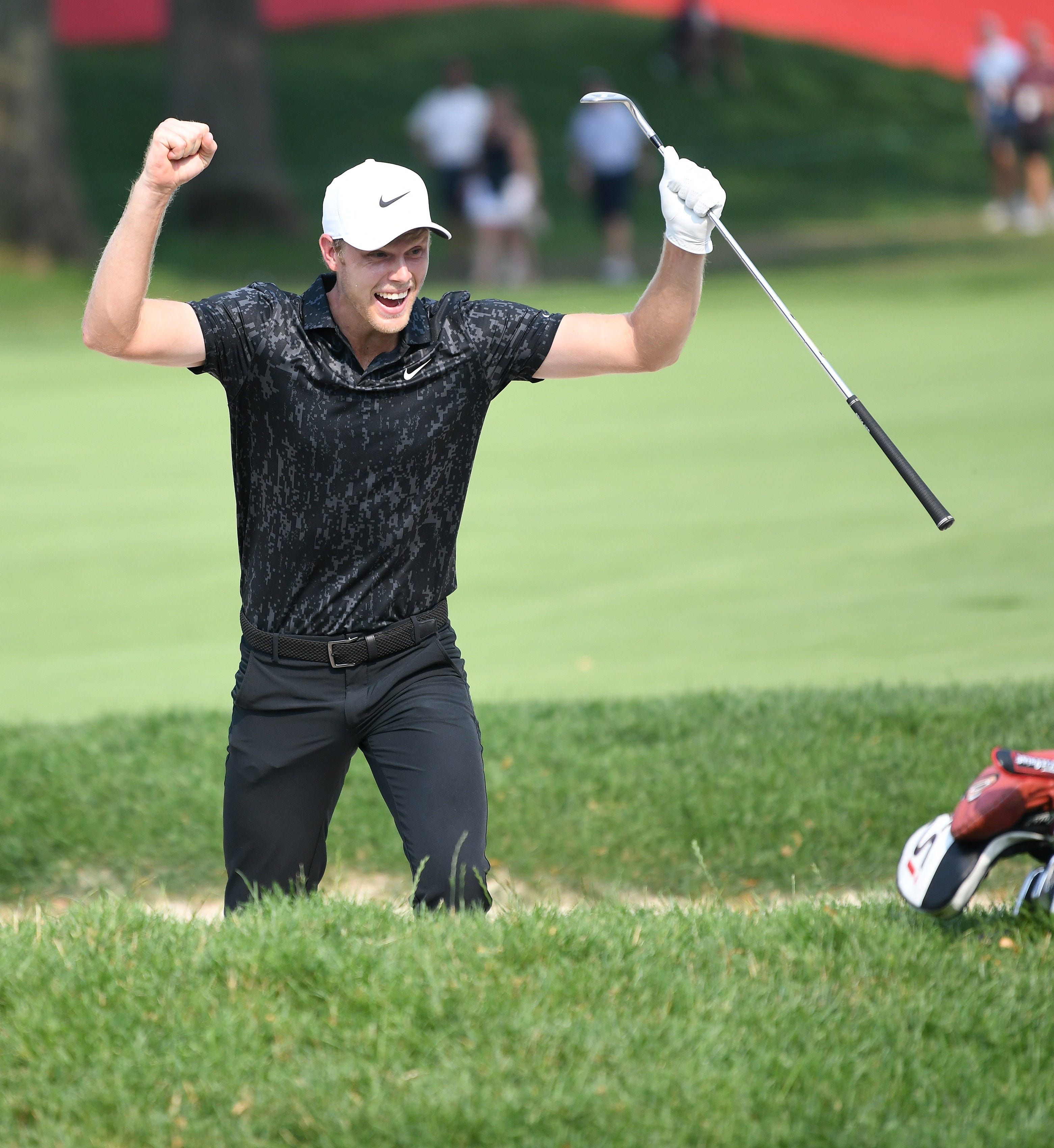 Cam Davis reacts after he hits an eagle out of the sand trap on 17 in the final round of the Rocket Mortgage Classic in 2021.