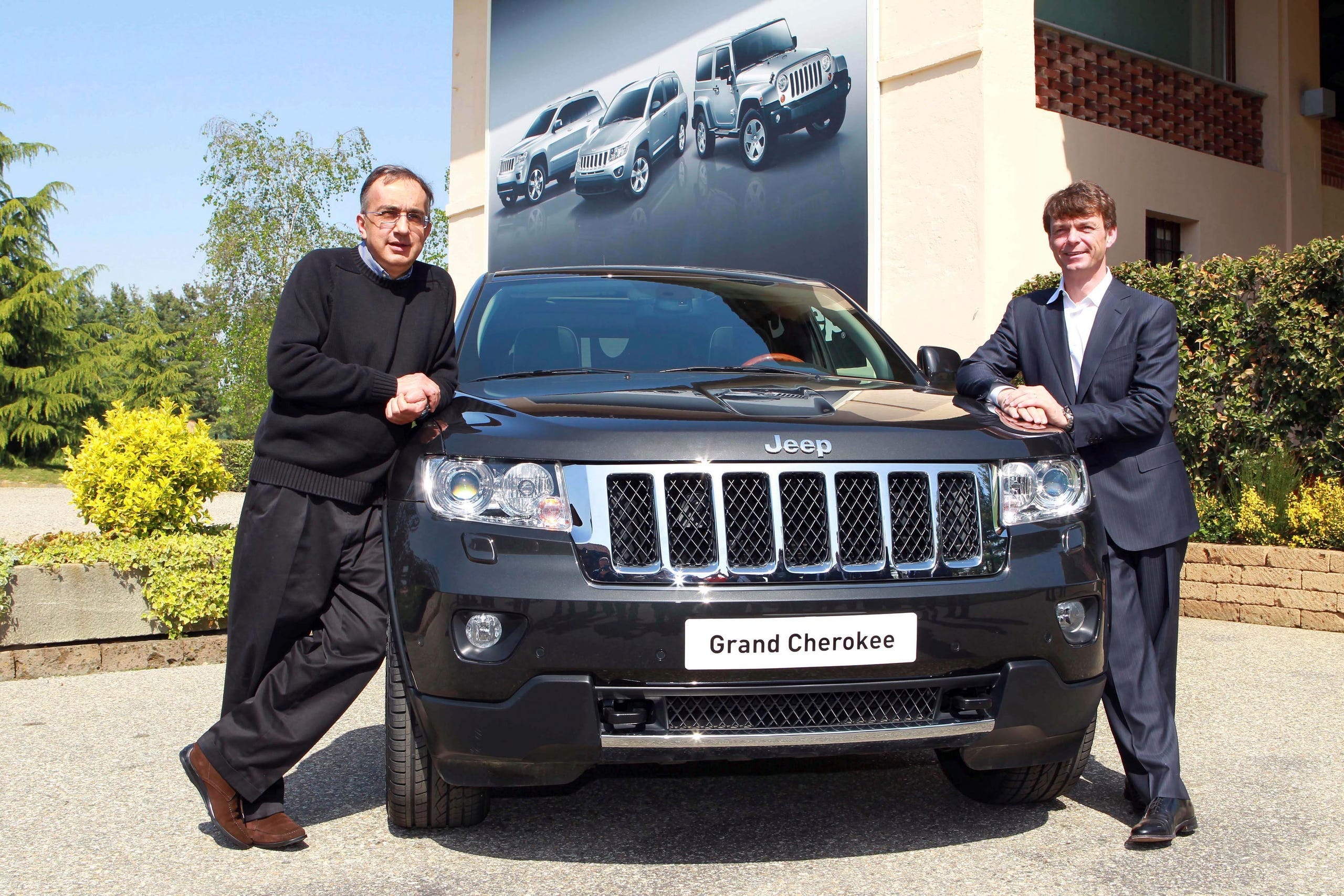 Fiat and Chrysler CEO Sergio Marchionne, left, poses with the new Jeep Grand Cherokee and Mike Manley, Jeep brand CEO, during a presentation near Turin, Italy, in 2011.