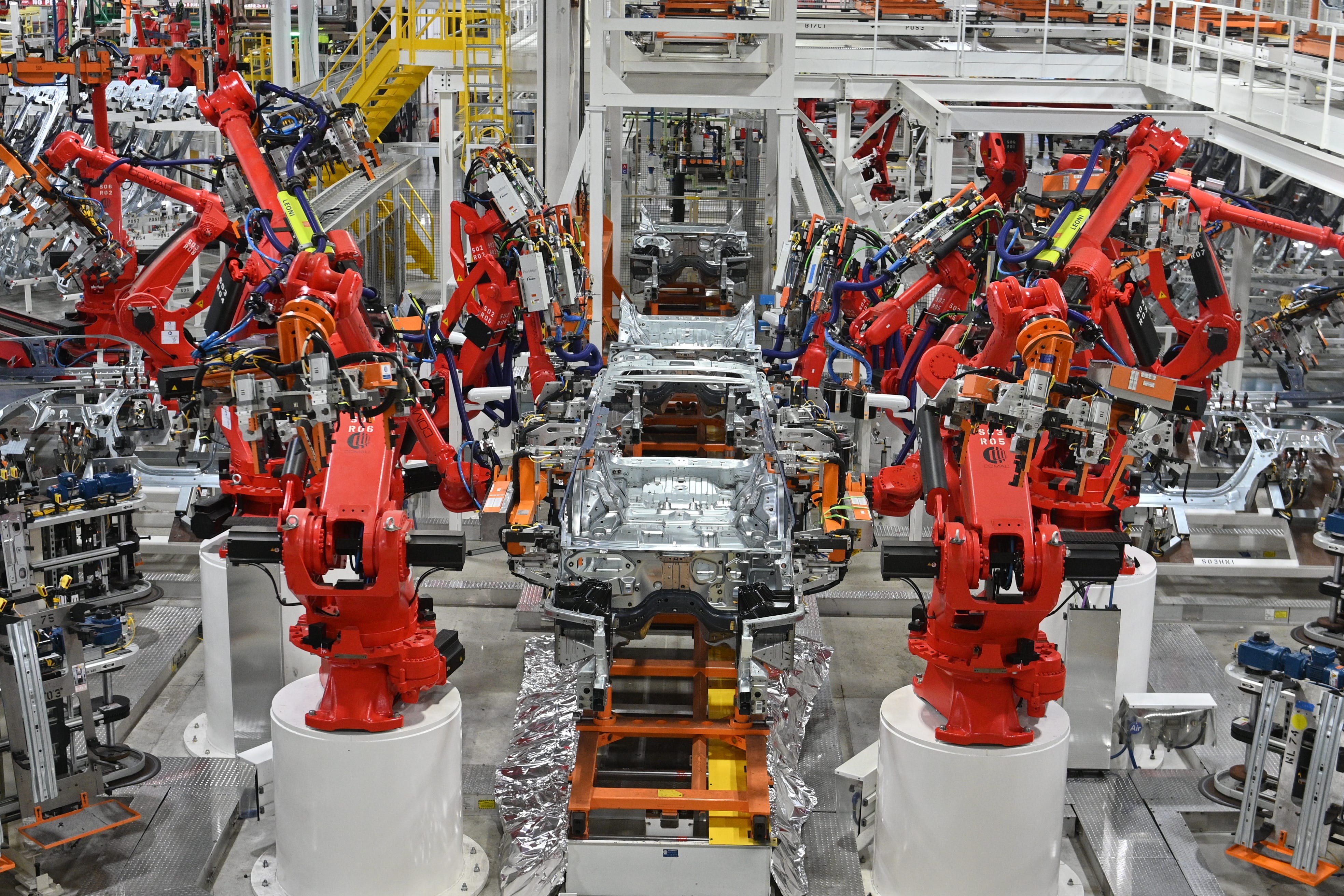 A 2021 Jeep Grand Cherokee L body goes through the Near-line Laser Radar, as robots measure hundreds of preprogrammed surface and alignment points, at the Stellantis Mack Assembly Complex in Detroit, June 10, 2021.