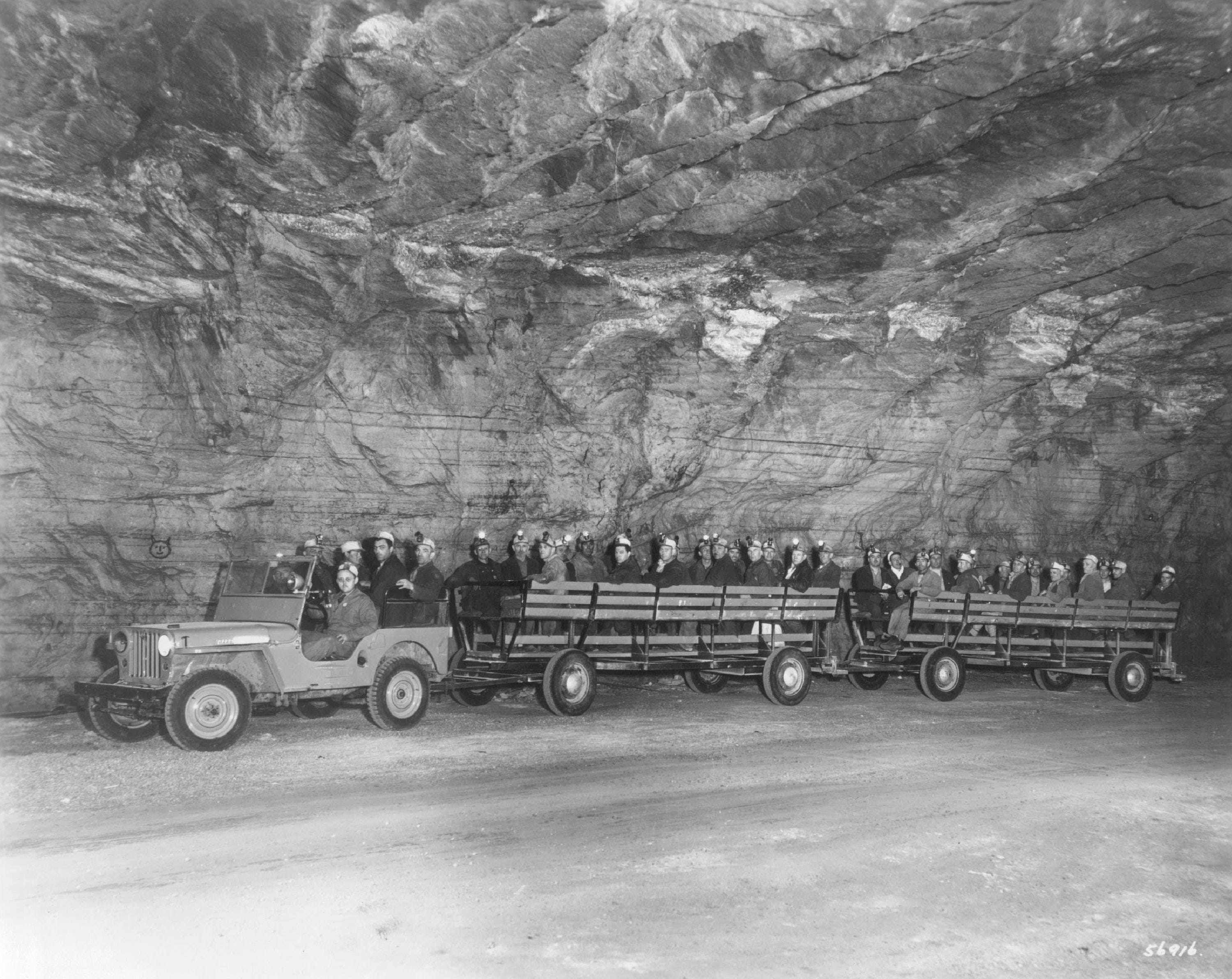 Over roads of pure salt a Jeep pulls men from the shaft bottom of the Detroit mine of the International Salt Company, October 20, 1950.  They travel a distance of 11/2 miles to and from the working places 1,137 feet beneath Detroit, where the air temperature is always 56 degrees the year round.