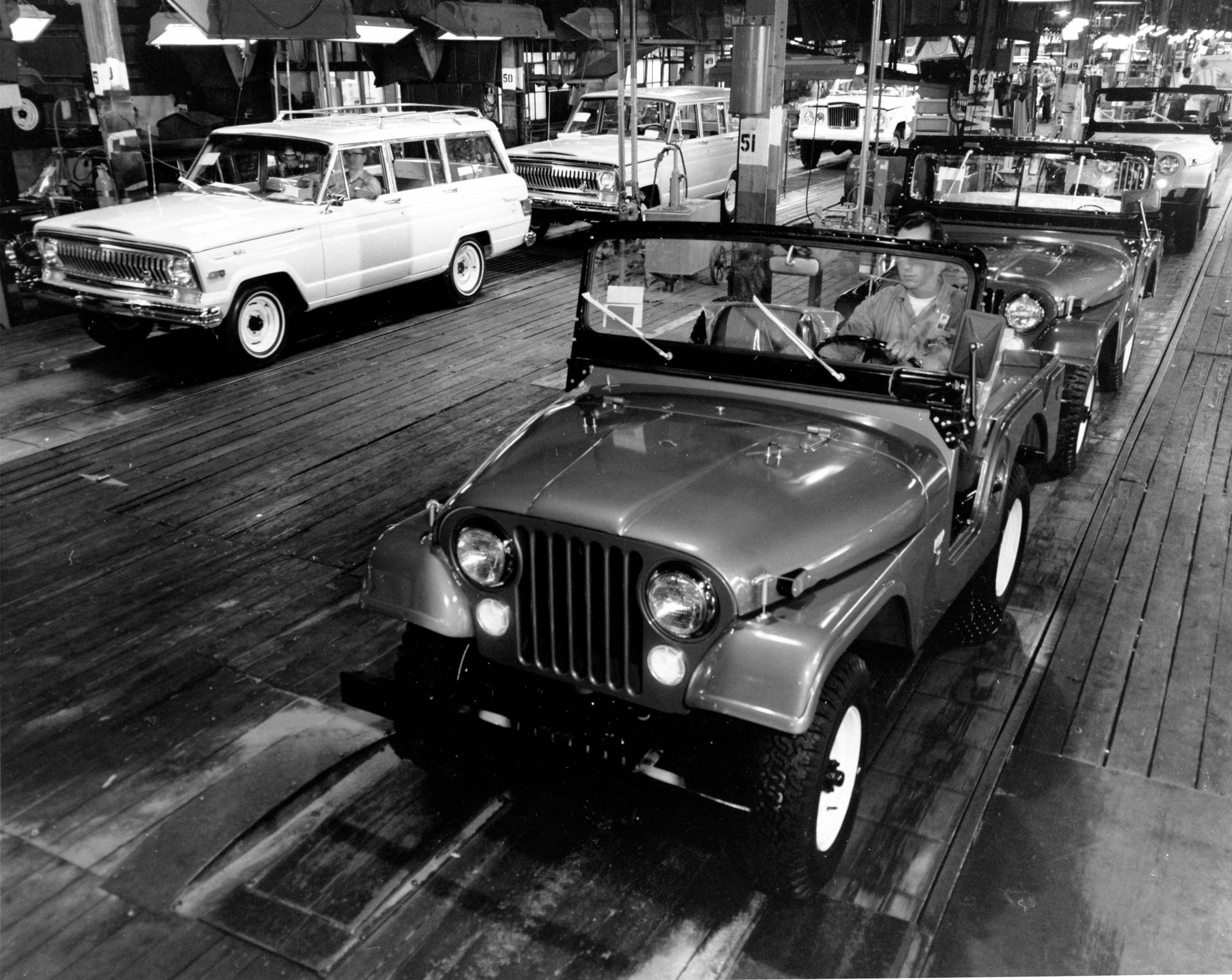 Two models come off the Jeep assembly line in Toledo in 1964.