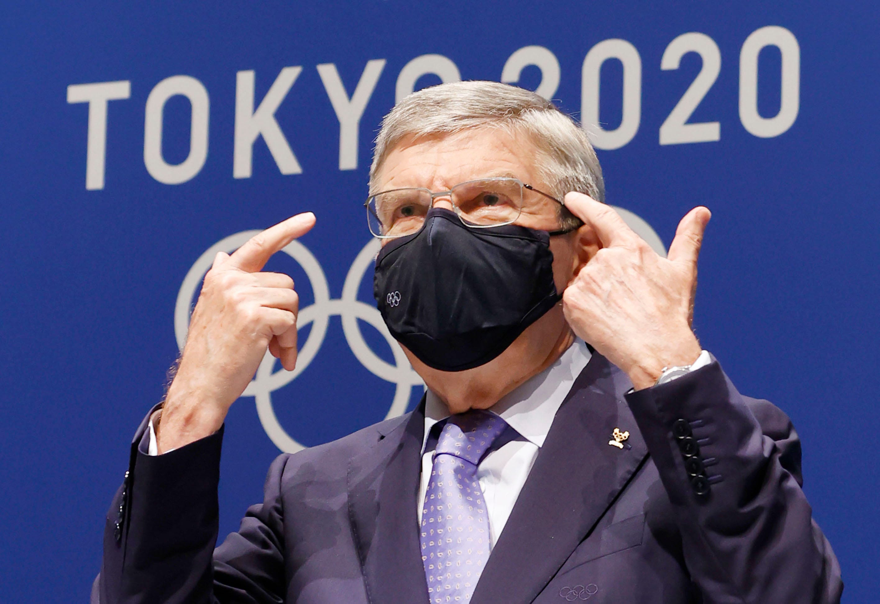 IOC President Thomas Bach gestures during a press conference at the Main Press Center, ahead of the Tokyo 2020 Olympic and Paralympic Games in Tokyo, Saturday, July 17, 2021. The first resident of the Olympic Village has tested positive for COVID-19, Tokyo Olympic organizers said on Saturday.