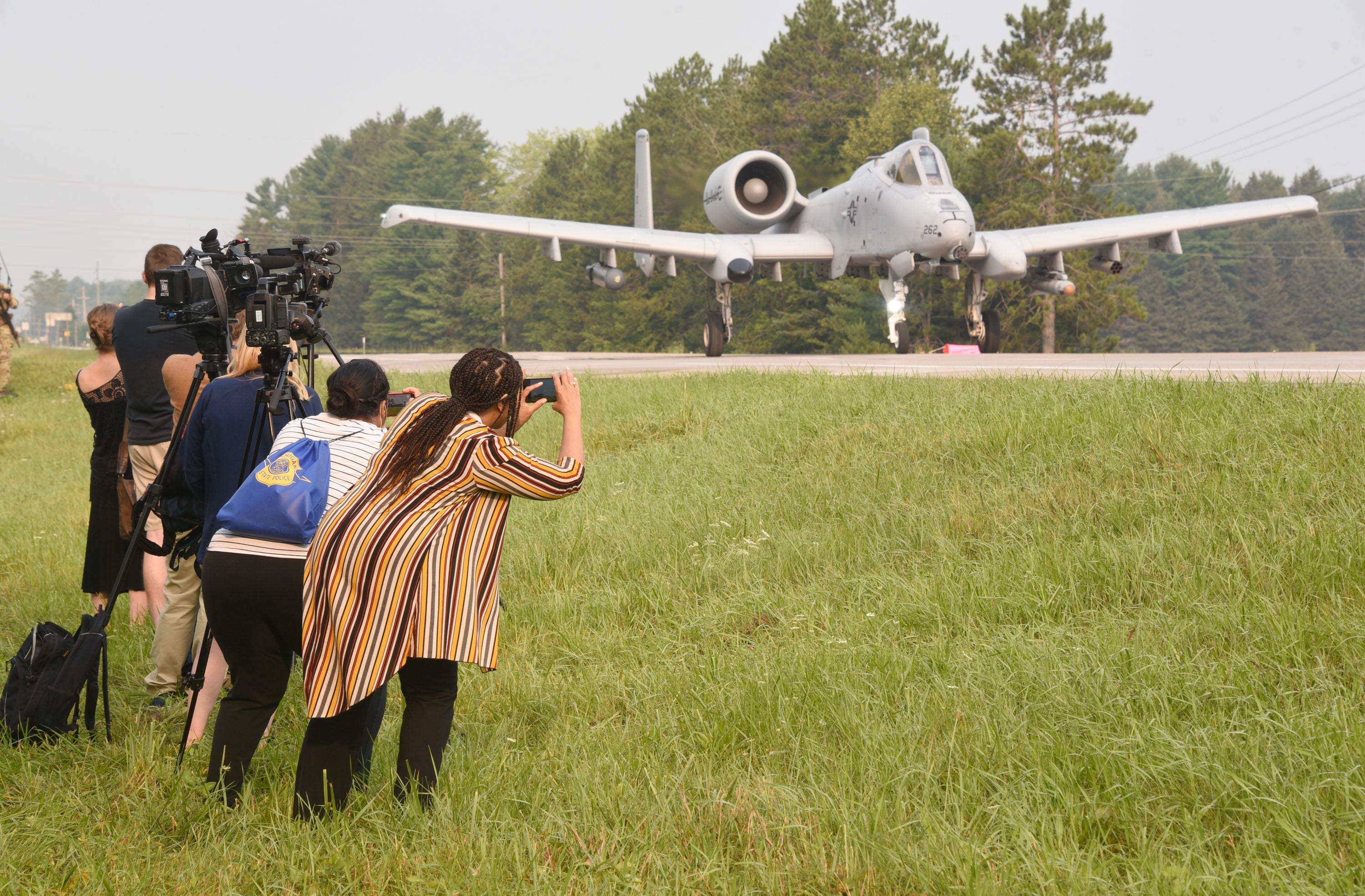 Media members photograph an A-10 Thunderbolt jet as it prepares to take off on highway M-32 Thursday, August 5, 2021 west of Alpena. Part of a war-readiness exercise, foru National Guard aircraft landed and took off from the closed highway.