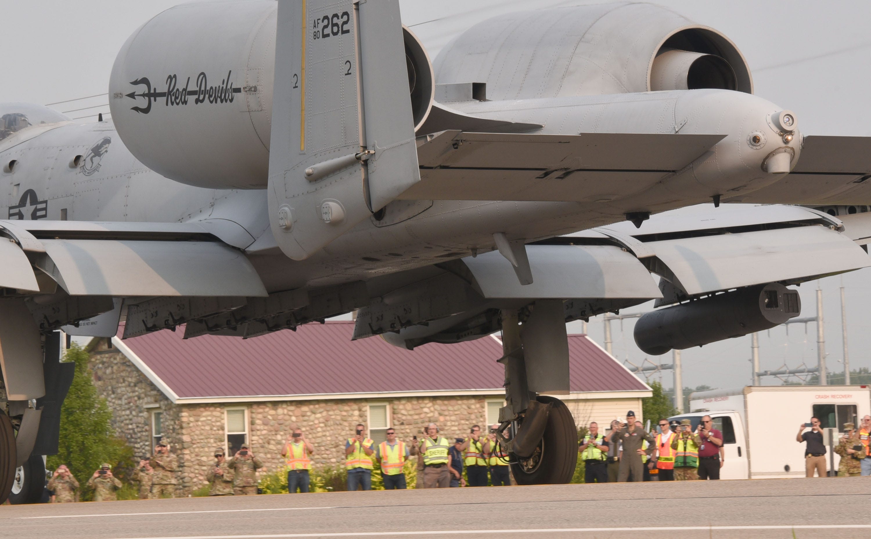 Rescue and military personnel view an A-10 Thunderbolt that had landed on highway M-32 west of Alpena Thursday, August 5, 2021. Part of a training exercise during Operation Northern Strike, four aircraft landed on the closed highway at part of a war-readiness event.