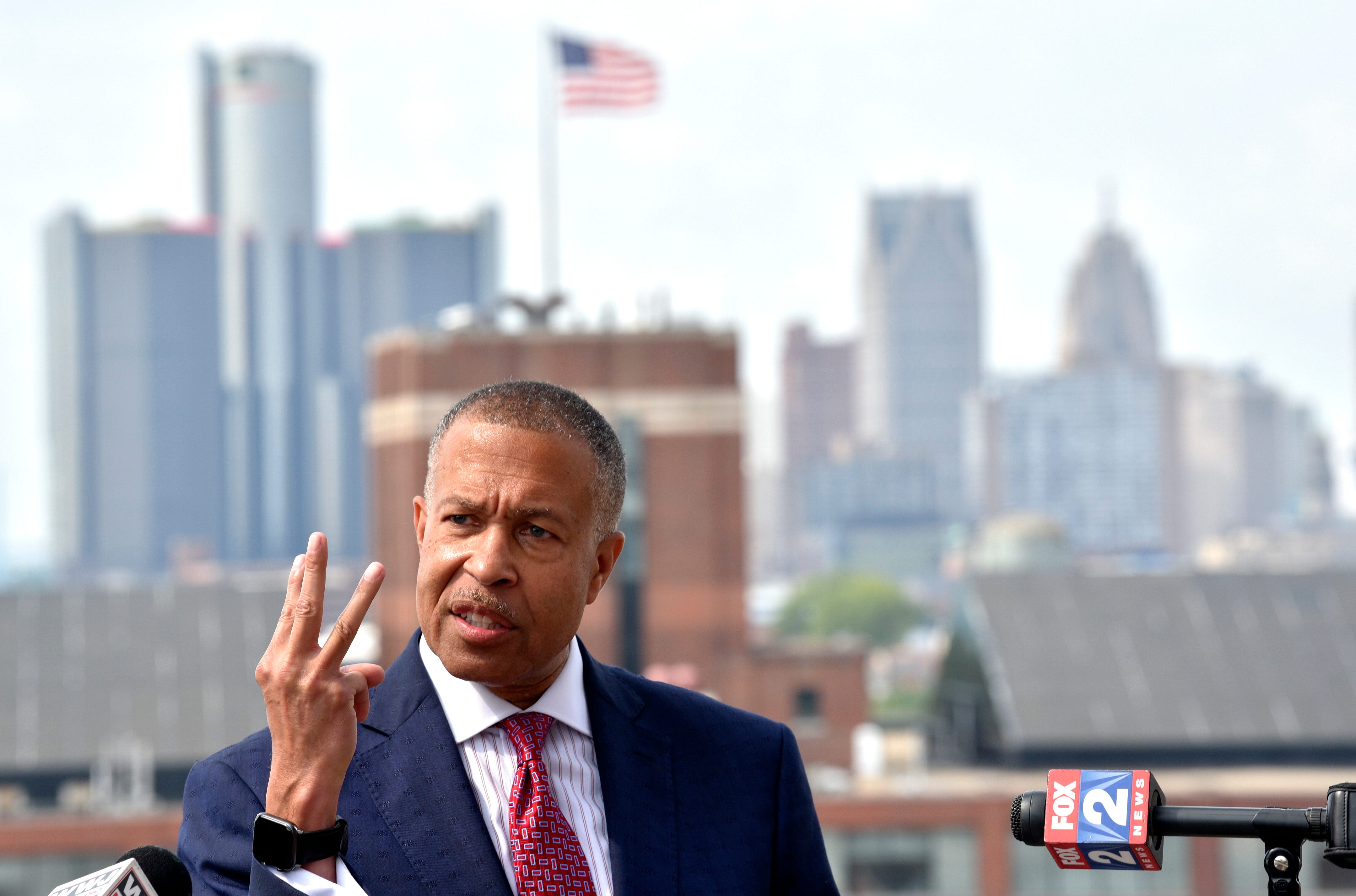 Former Detroit Police Chief James Craig raises three fingers and says he's worked in law enforcement in three cities over 44 years as he stands in front of the Detroit skyline and announces his Republican candidacy for Michigan governor, Tuesday afternoon, September 14 ,2021.