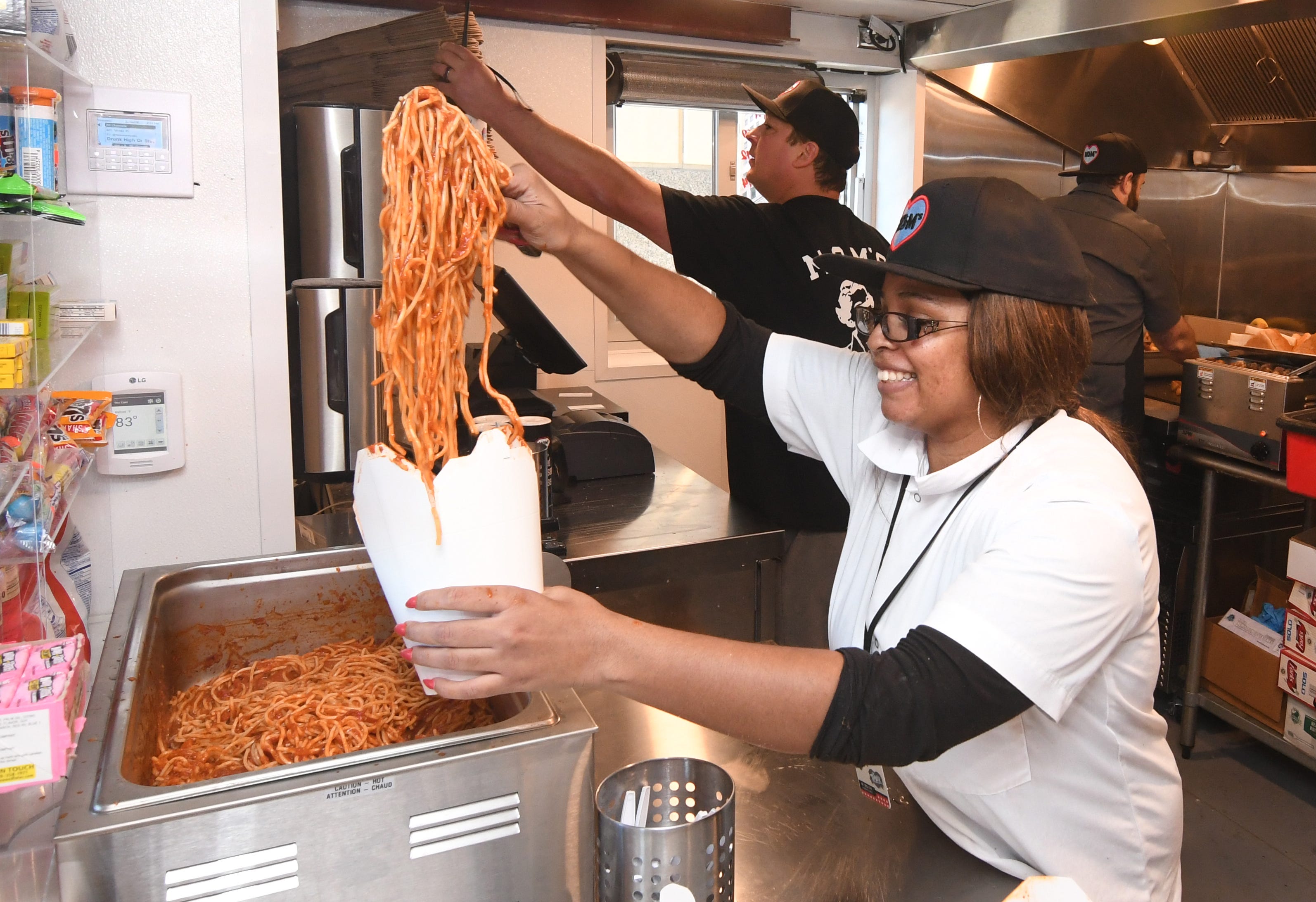 Onistee Artis serves the famous Mom's Spaghetti during the opening of rapper Eminem's restaurant in downtown Detroit on Wednesday, September 29, 2021.