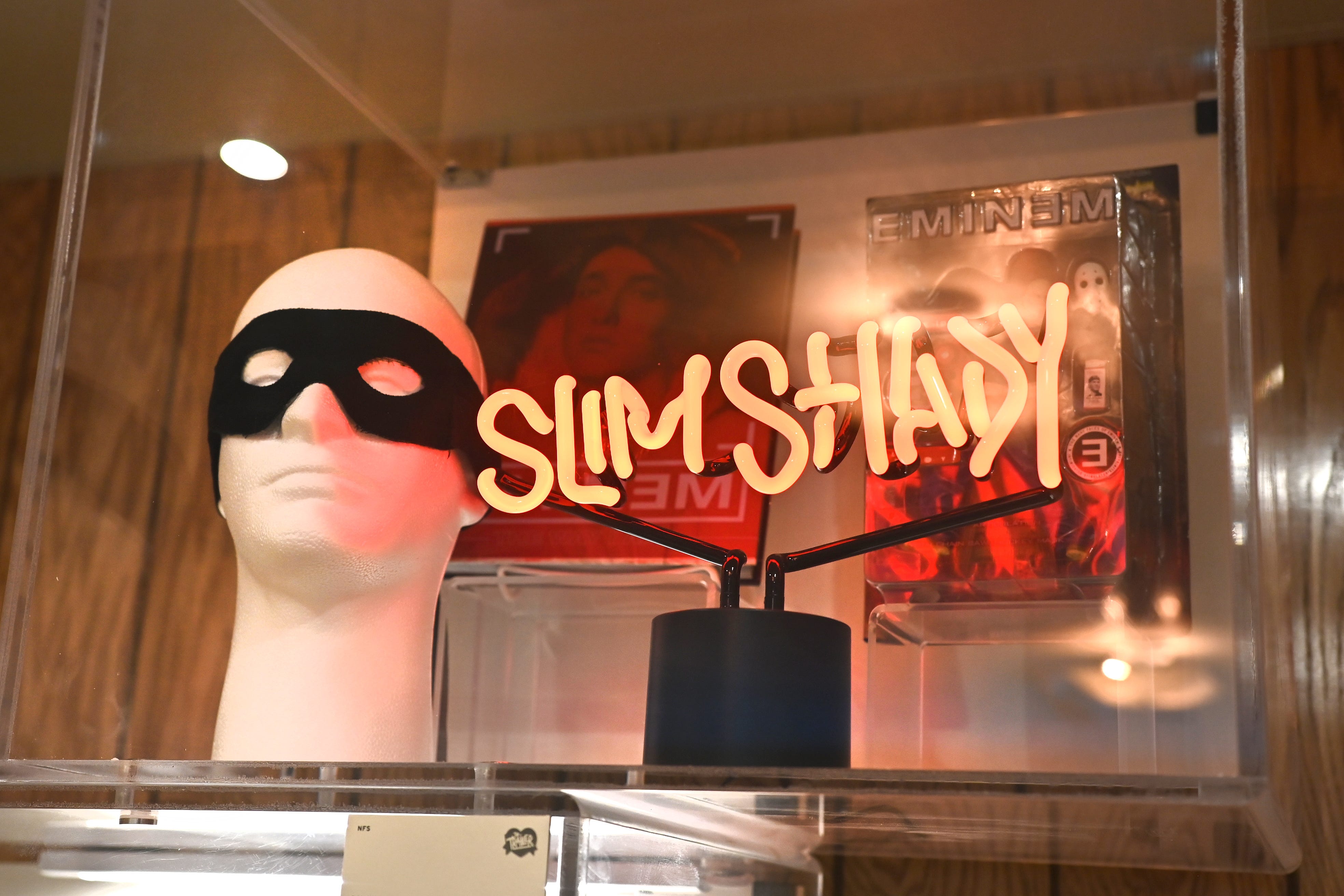 Eminem’s Robin mask and a Slim Shady neon sign are on display inside The Trailer Shop at Mom’s Spaghetti.