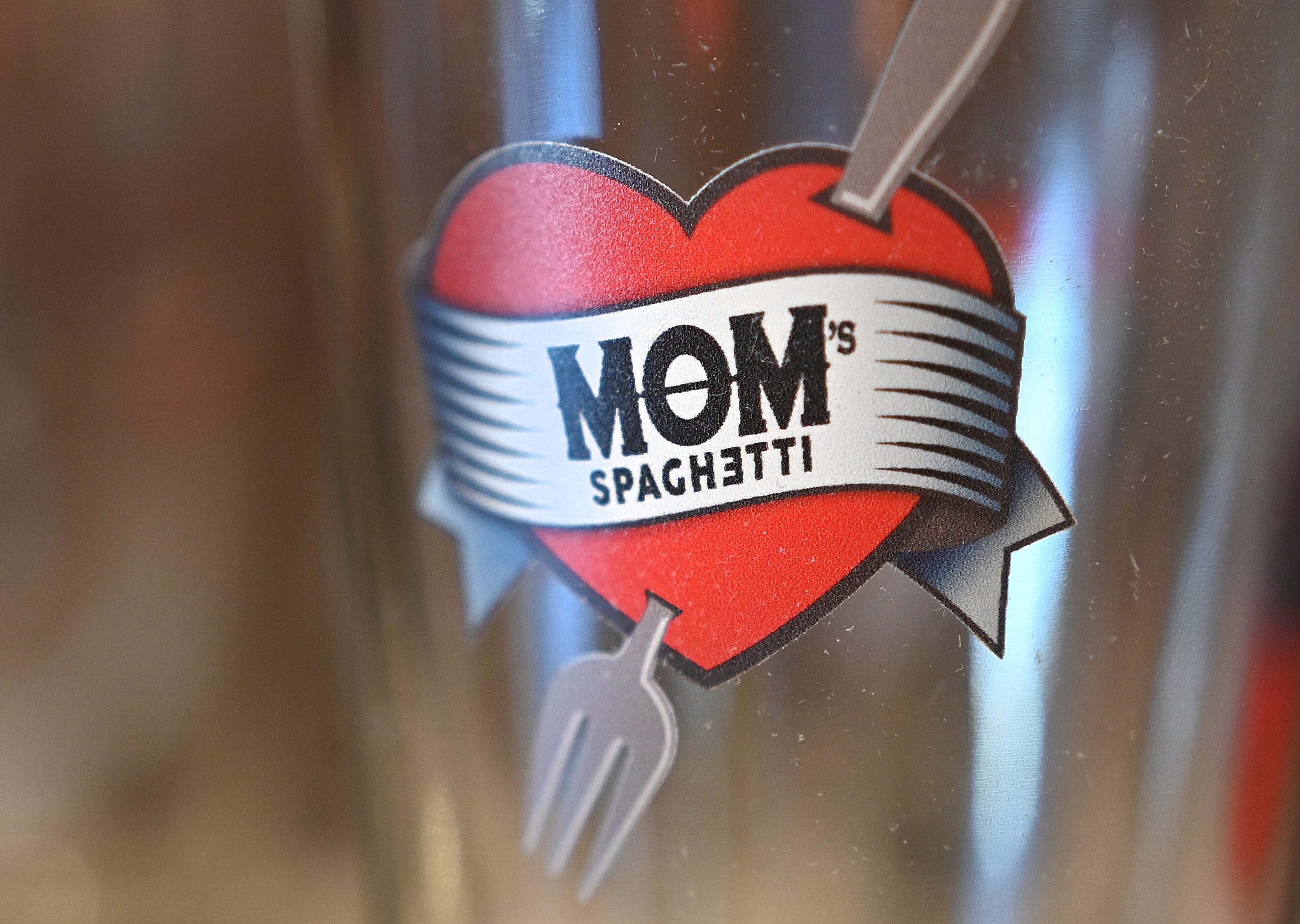 A beer glass with the unique Mom's Spaghetti logo is one  of many items for sale at The Trailer retail shop.