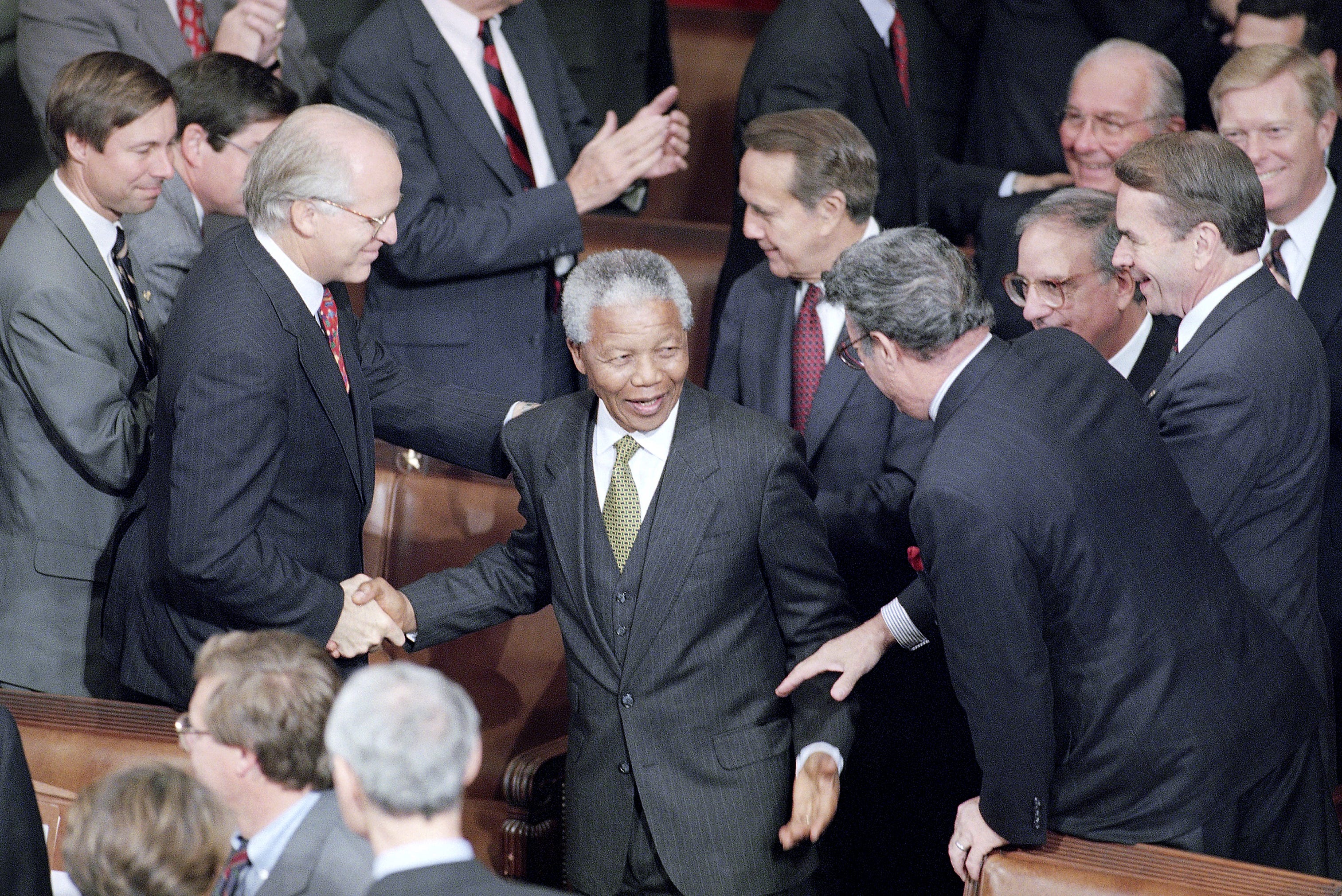South African President Nelson Mandela is greeted by members of Congress prior to his address to a joint meeting of Congress on Thursday, Oct. 6, 1994 on Capitol Hill. From left are Rep. Christopher Shays, R-Conn.; Mandela; Senate Minority Leader Bob Dole of Kansas; Rep. Peter King, R-N.Y.; Senate Majority Leader George Mitchell of Maine; House Minority Leader Bob Michel of Illinois; Rep. Dale Kildee, D-Flint; and House Majority Leader Richard Gephardt of Missouri.