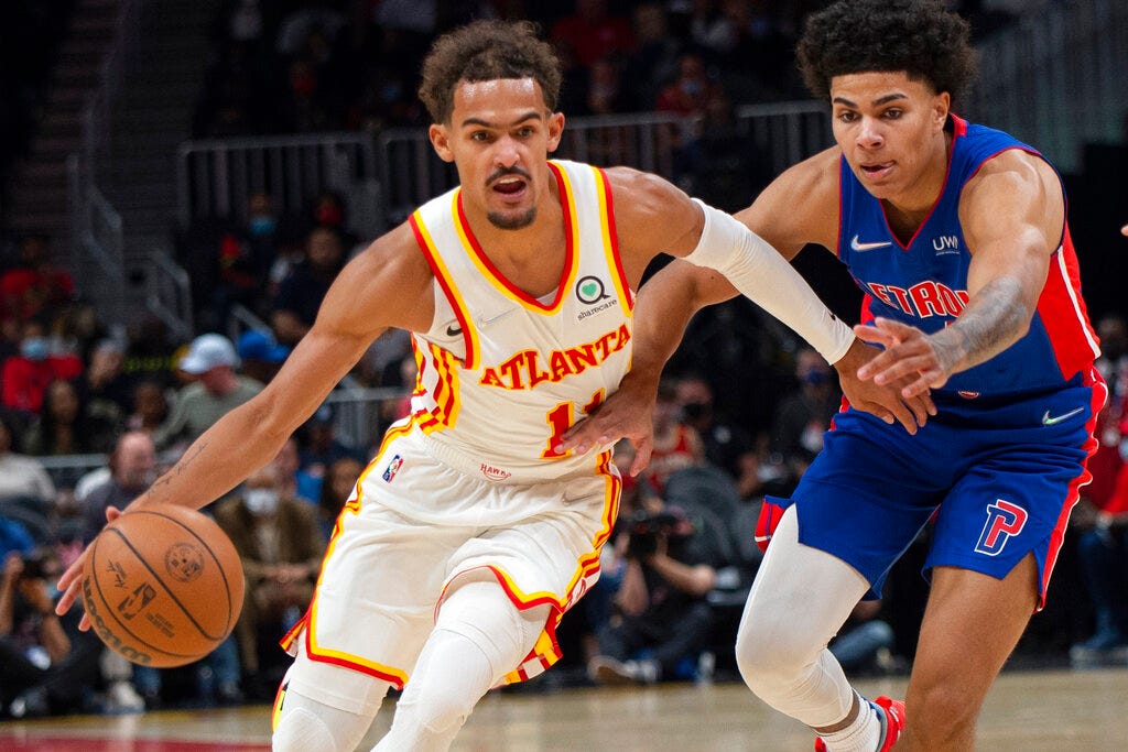 Hawks guard Trae Young (11) dribbles past Pistons guard Killian Hayes during the first half of Monday's game in Atlanta.