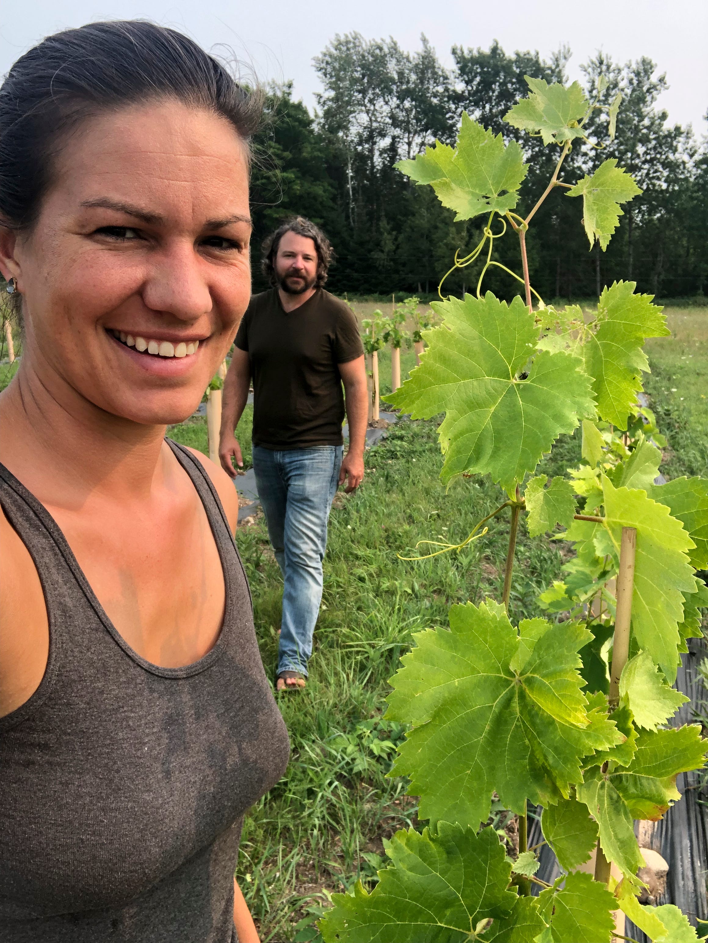Kate Leese and Adam Kendall among their Saperavi vines, a varietal that originates from the Georgia, the country. Unlike most red grapes, Saperavi has both red skin and red flesh.