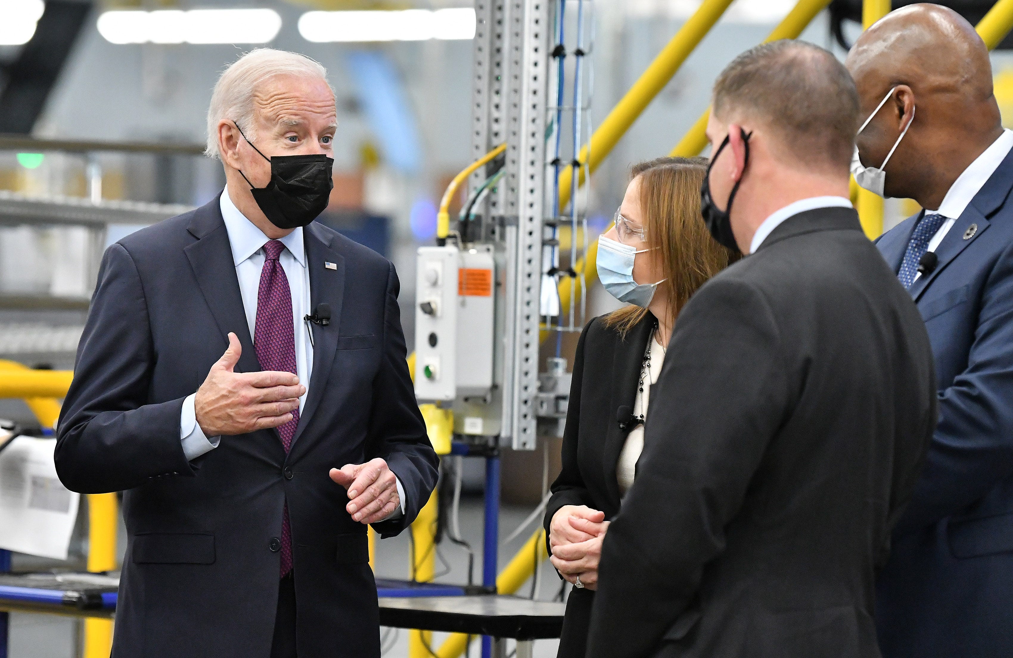 From left, President Joe Biden talks with GM CEO Mary Barra, U.S. Labor Secretary Marty Walsh and UAW President Ray Curry during his visit at the General Motors Factory ZERO.