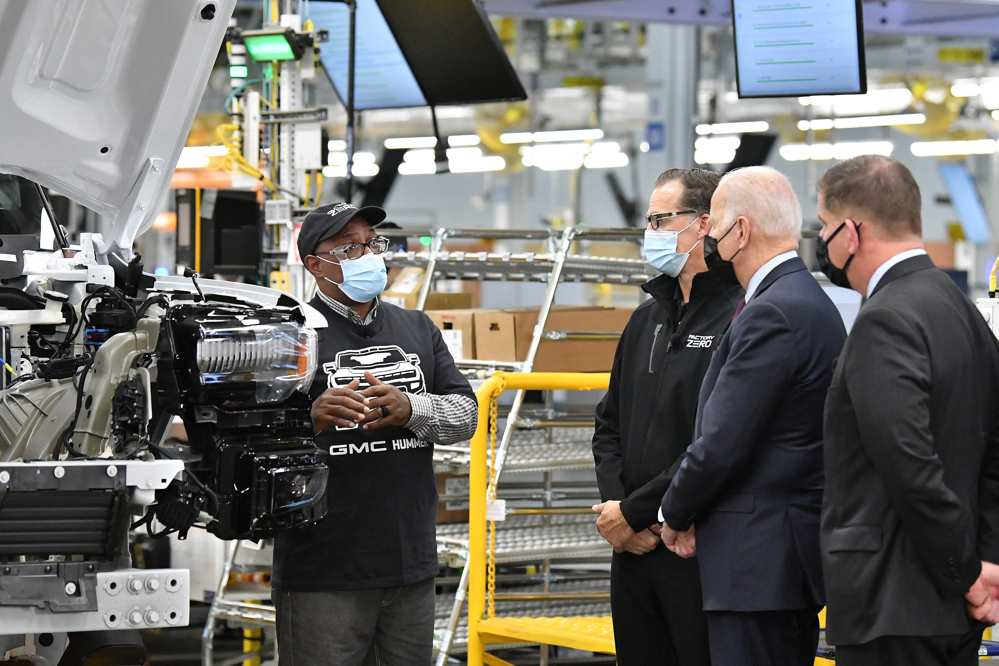 From left, quality core member Hayward Miller talks about the Hummer EV electrical validation with General Motors Factory ZERO plant director Jim Quick, President Joe Biden and U.S. Labor Secretary Marty Walsh.