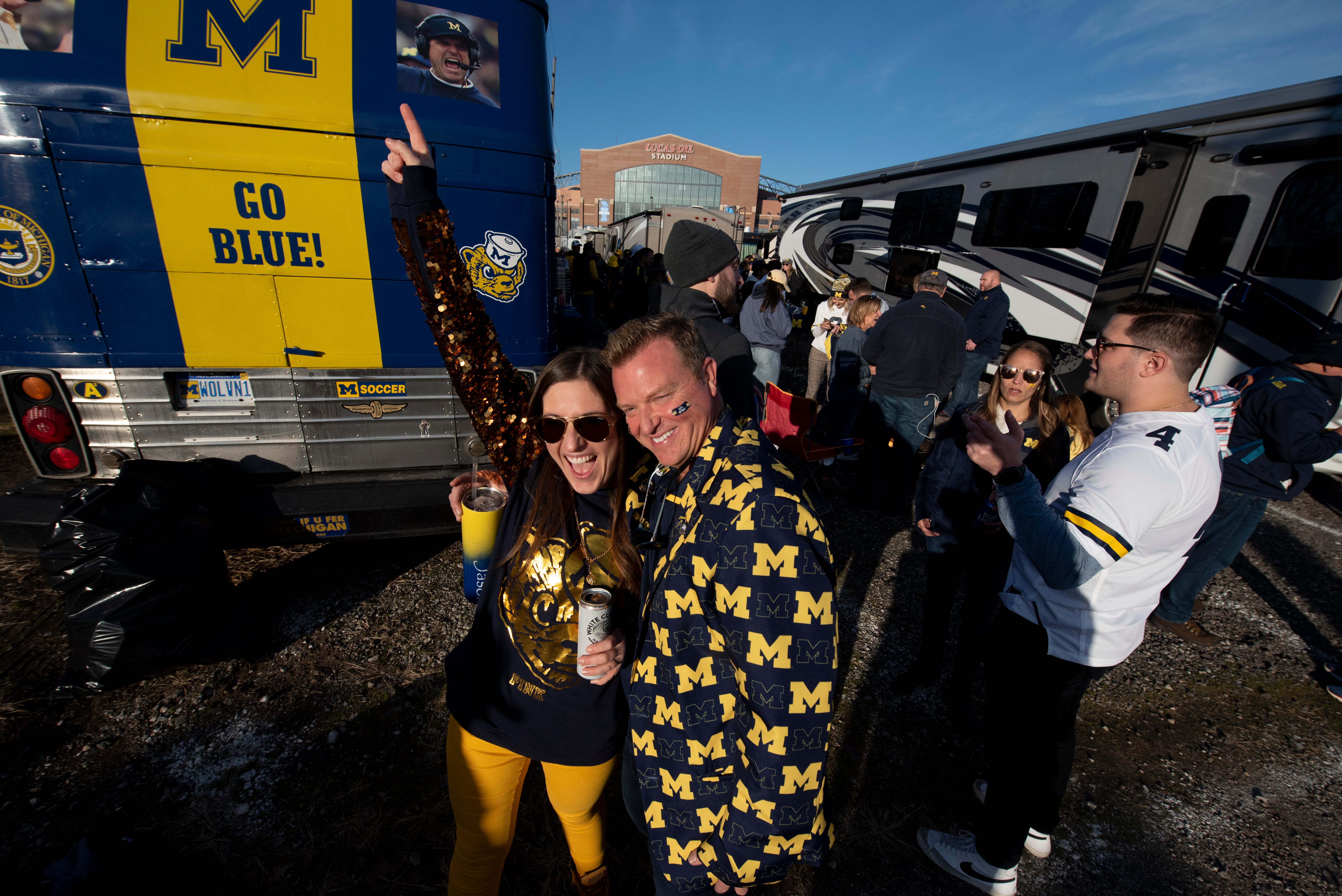 Brittany Thompson, of Wixom, left, and Jason Huntoon, of Novi, tailgate together outside of Lucas Oil Stadium before the start of the Big Ten championship game in Indianapolis, December 4, 2021.