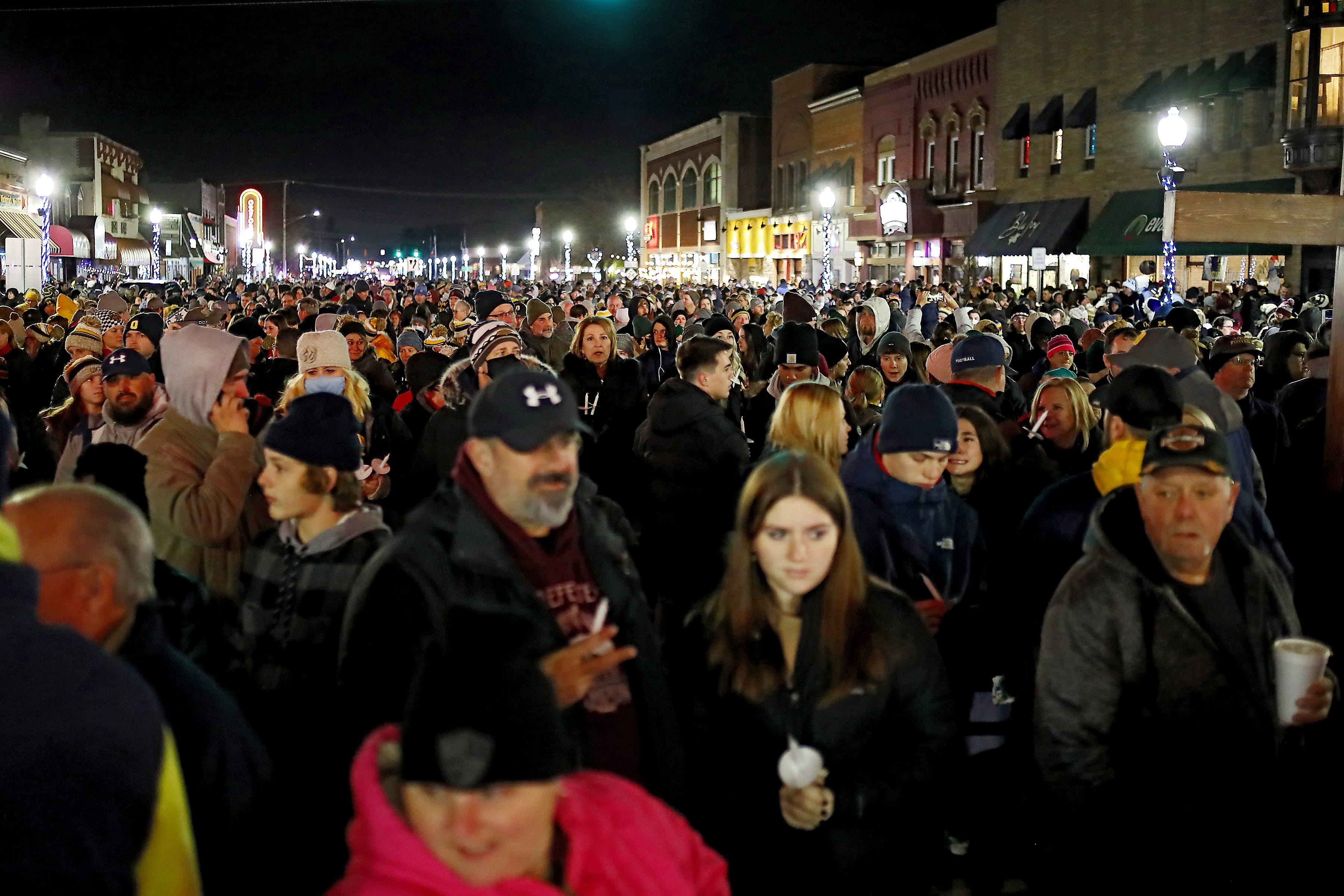 Thousands of people from around metro Detroit gather in downtown Oxford for a candlelight vigil on Friday, Dec. 3, 2021 in memory of the four Oxford High School students who died in a school shooting Tuesday.