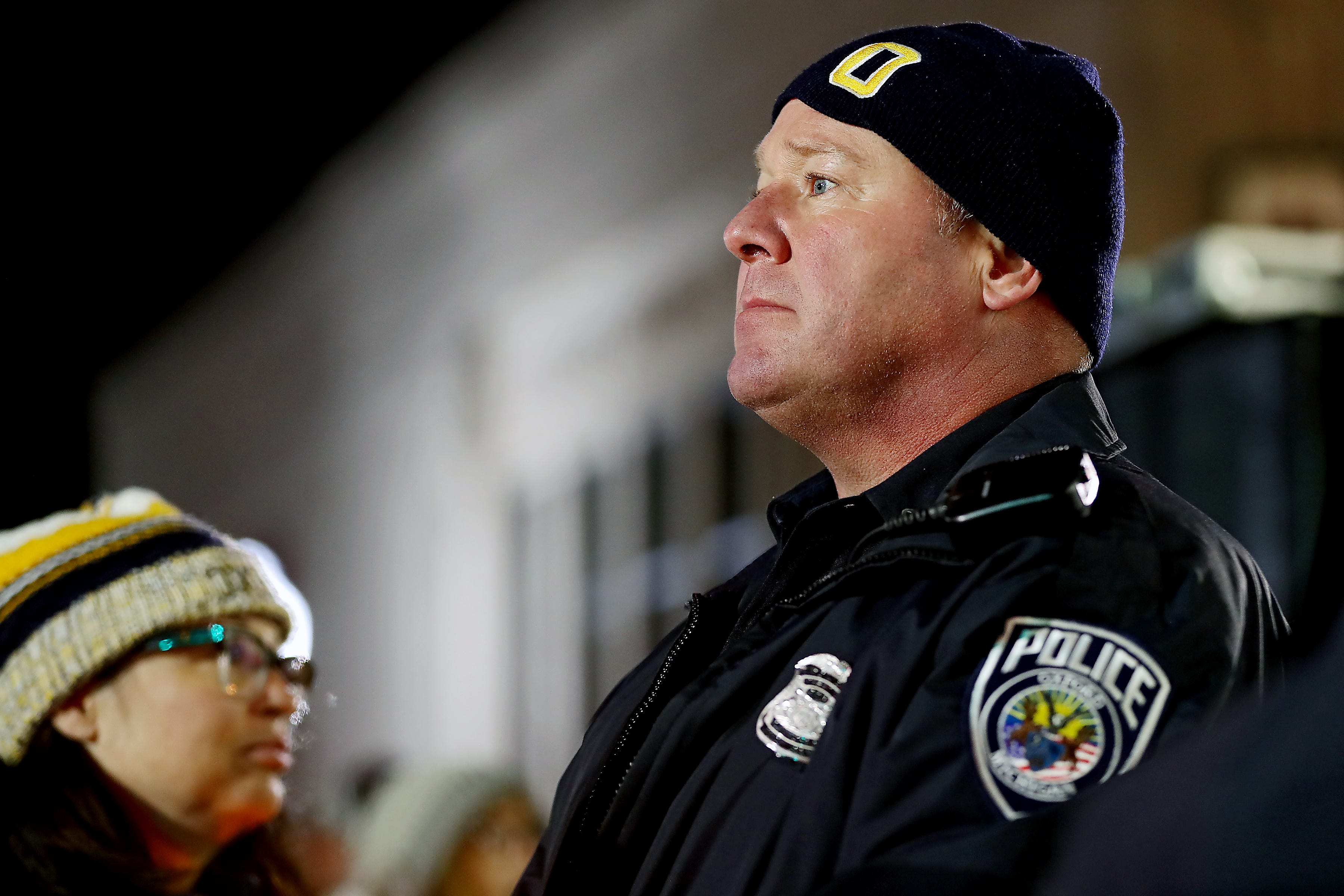 An Oxford police officer stands watch during a candlelight vigil on Friday, Dec. 3, 2021 in downtown Oxford.