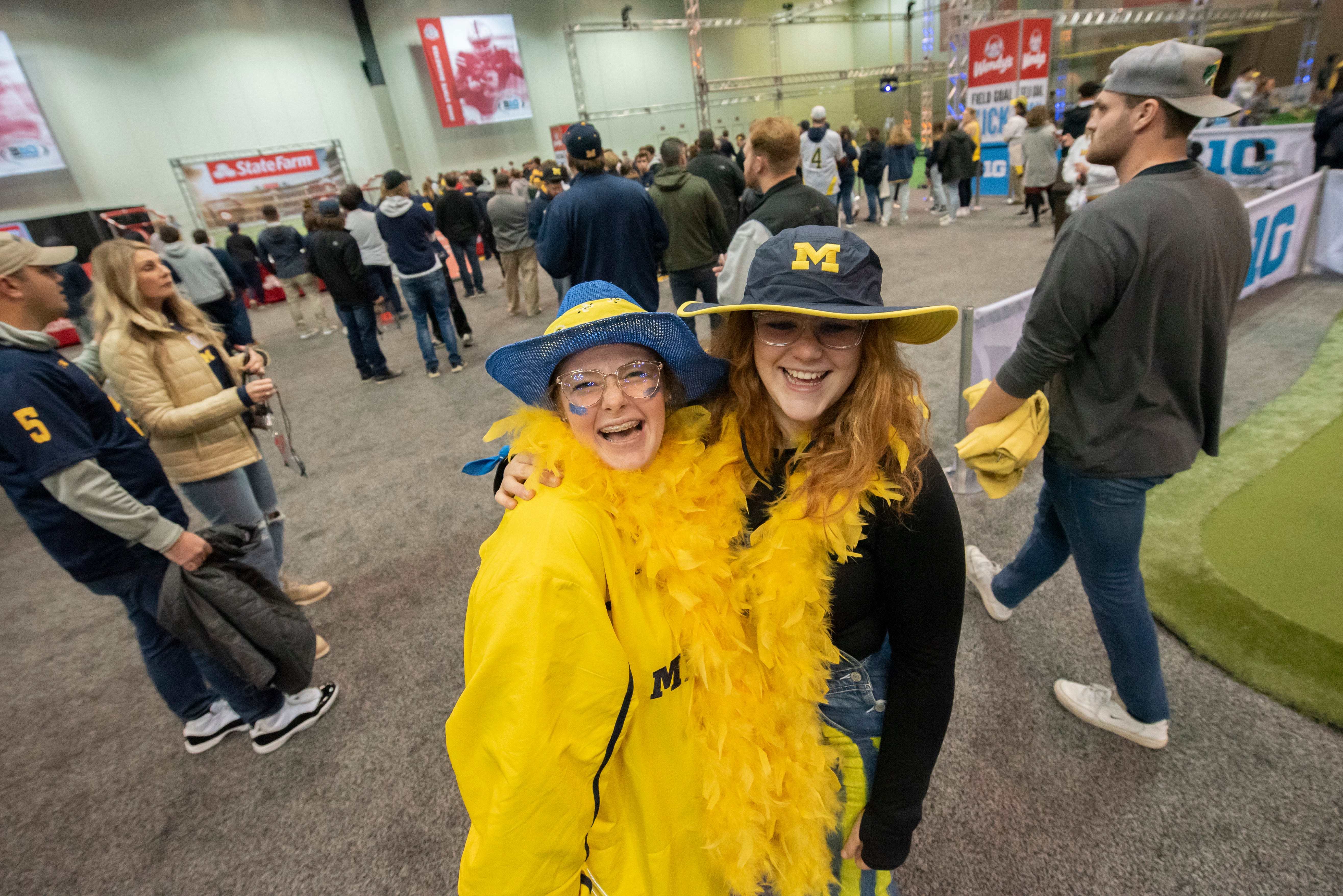 Kayley Gotham, left, and Sam Bocock, of South Haven, have fun at the Fan Fest at the Indiana Convention Center, before the start of the Big Ten championship game.