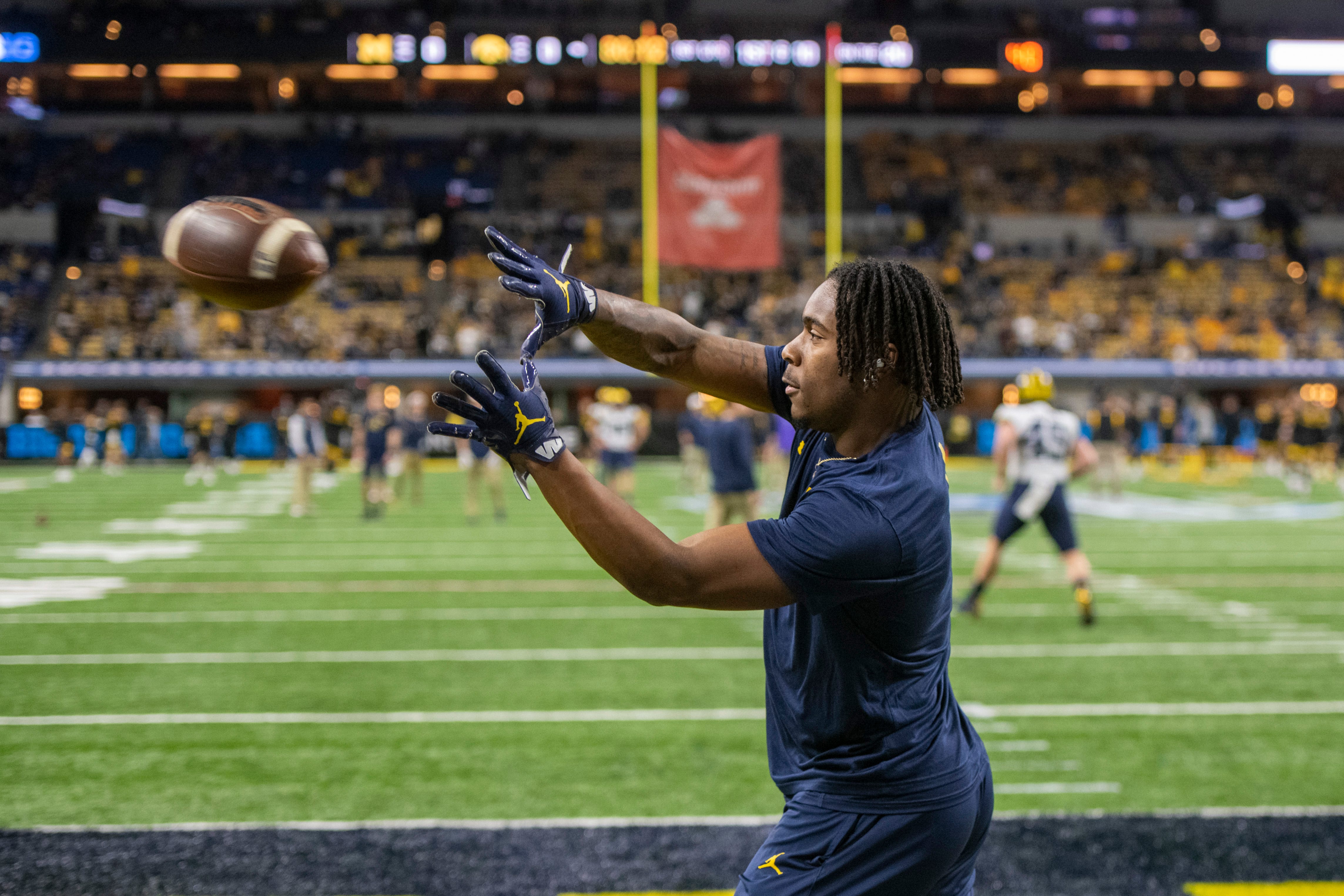 Michigan wide receiver Andrel Anthony catches a pass during warmups before the start of the Big Ten championship game.