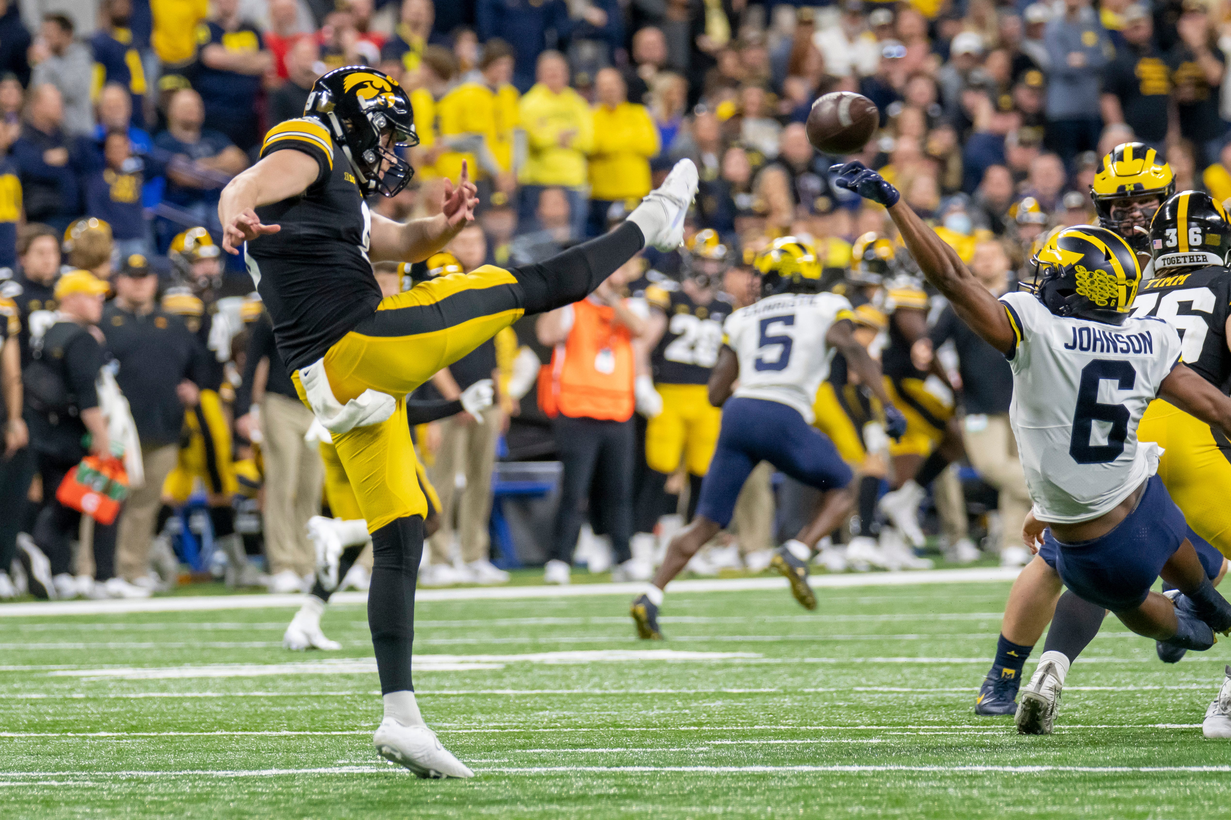 Michigan wide receiver Cornelius Johnson blocks a punt by Iowa punter Tory Taylor during the fourth quarter.