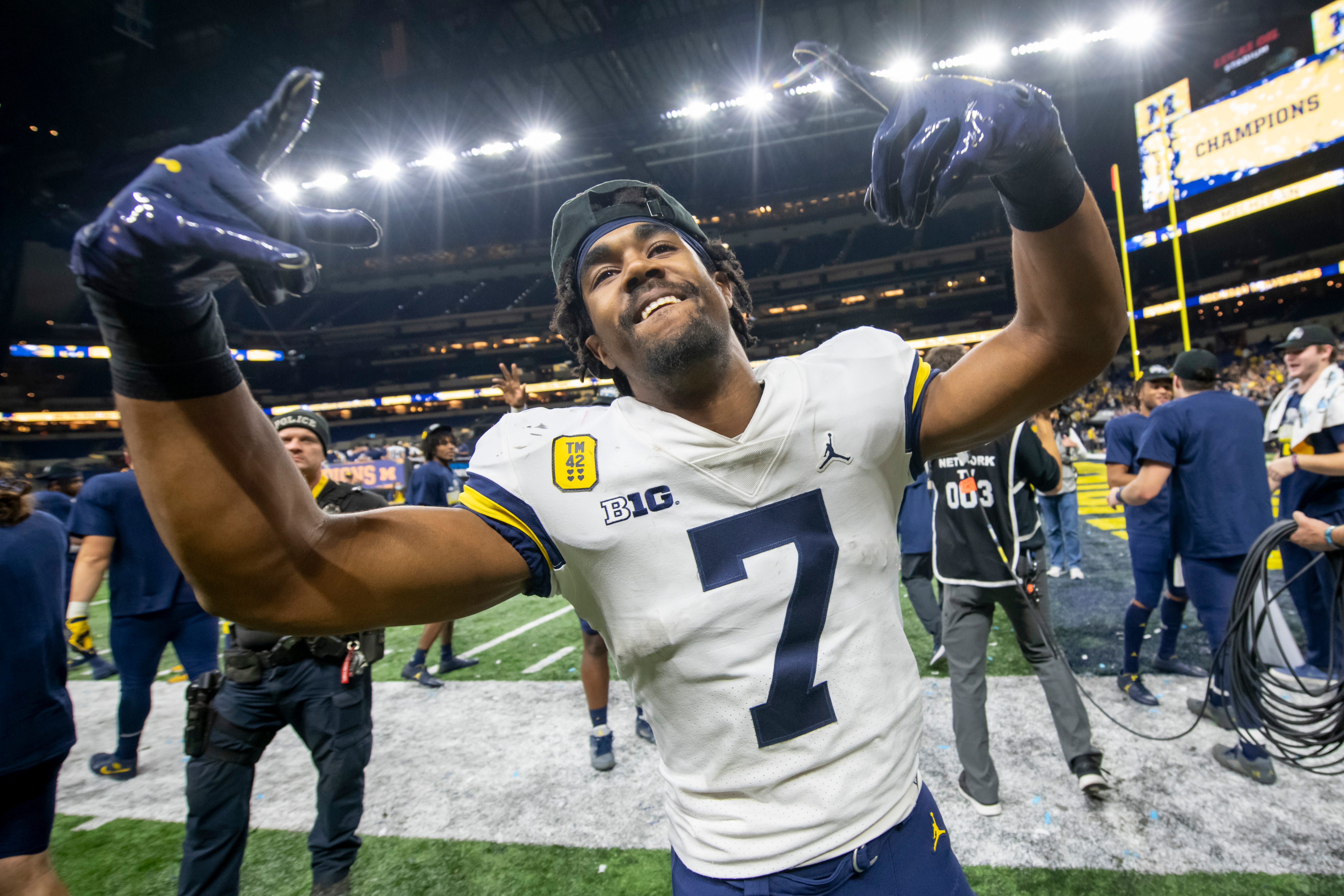 Michigan running back Donovan Edwards celebrates on the field after the University of Michigan defeated the University of Iowa 42-3 to win the Big Ten championship.