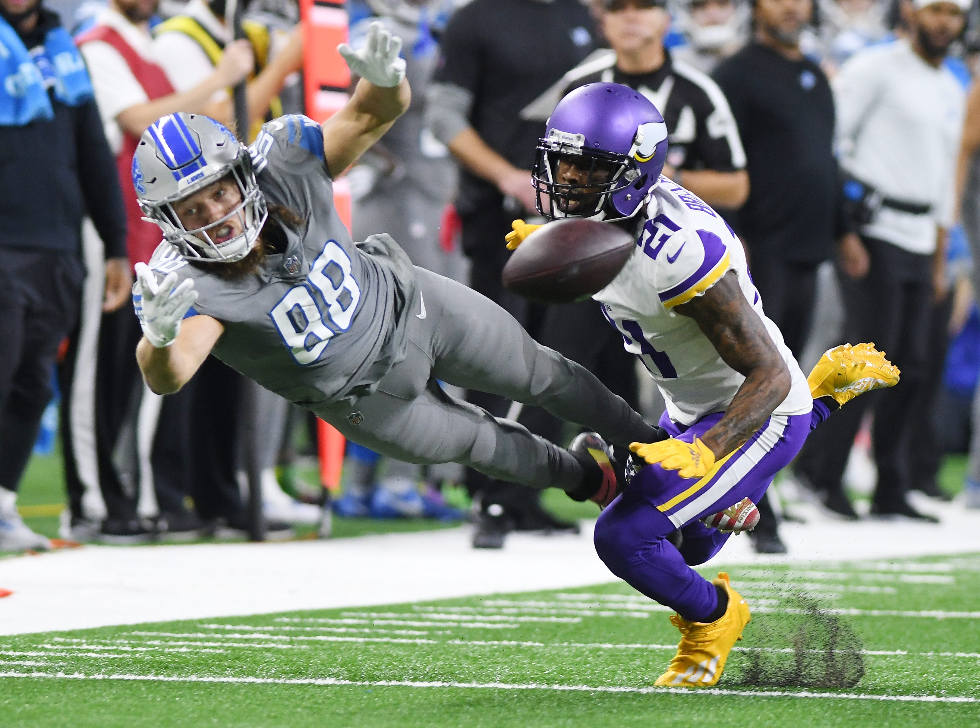 Lions tight end T.J. Hockenson gets fouled, going for a reception, by Vikings' Bashaud Breeland in the third quarter.
