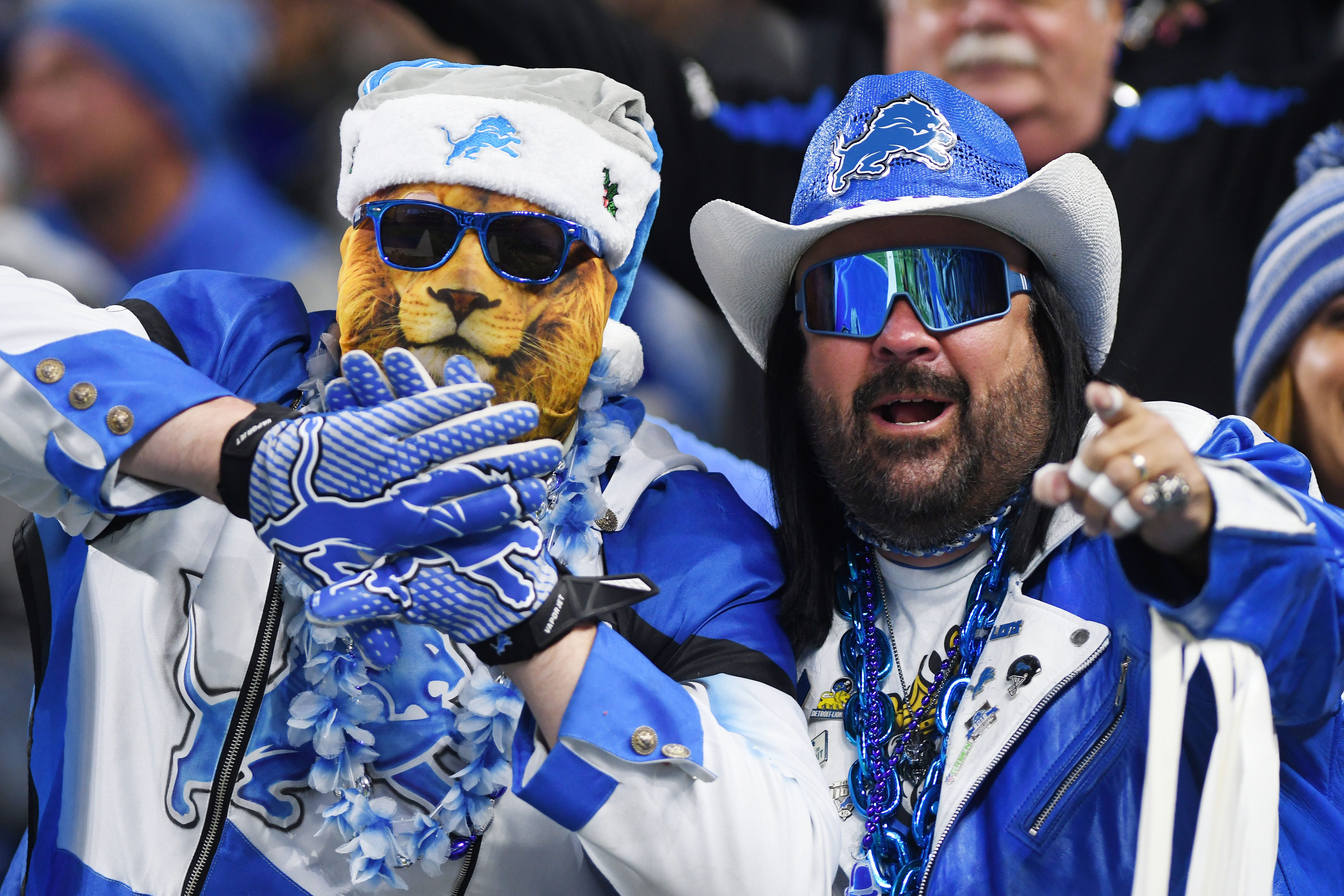 Faithful Lions fans, in full outfits, cheer on the team as they get their first victory of the year.