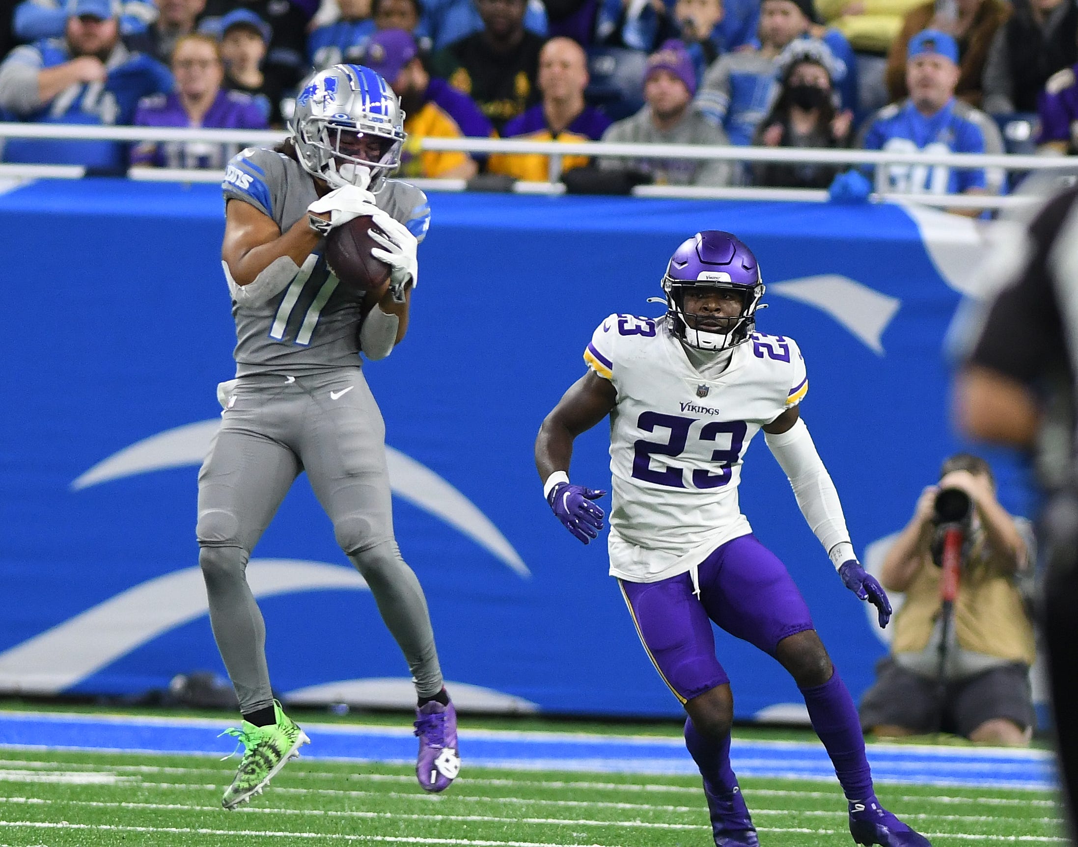 The Lions' Kalif Raymond pulls in a reception with the Vikings' Xavier Woods defending in the second quarter.