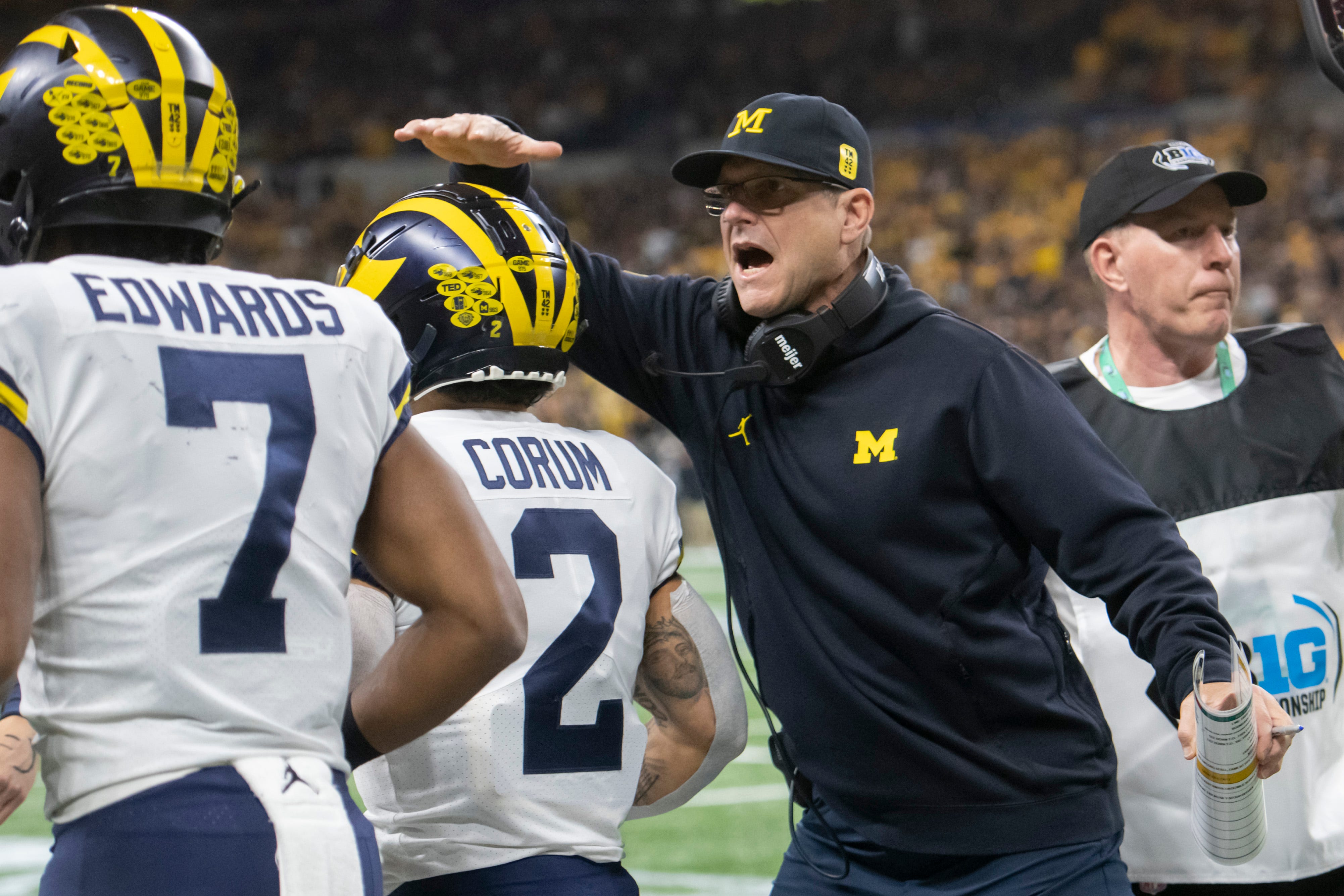 Michigan head coach Jim Harbaugh celebrates with running back Blake Corum after Corum scored a touchdown during the first quarter.