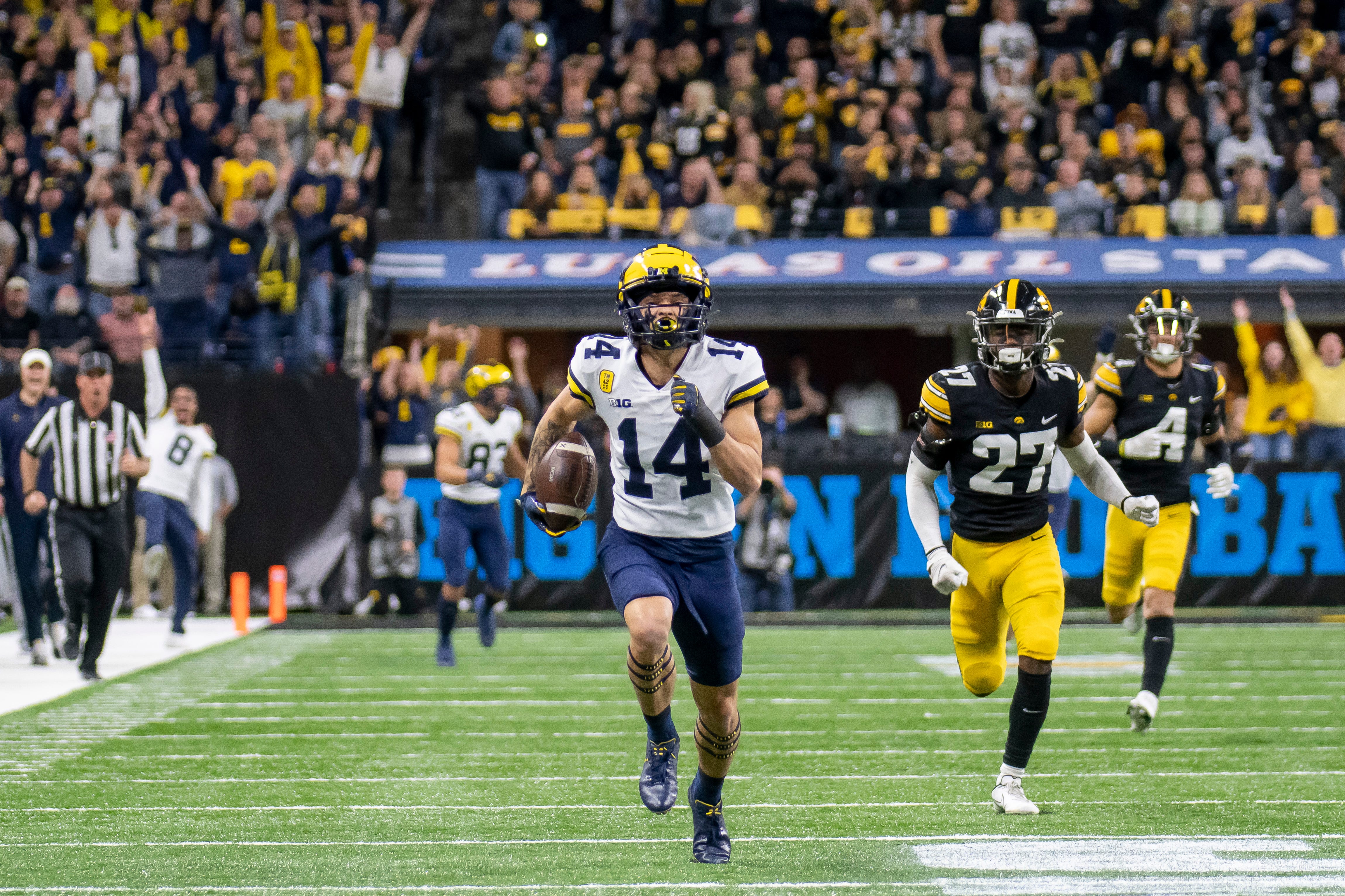 Michigan wide receiver Roman Wilson runs for a touchdown during the first quarter of the Big Ten Championship Game against Iowa.