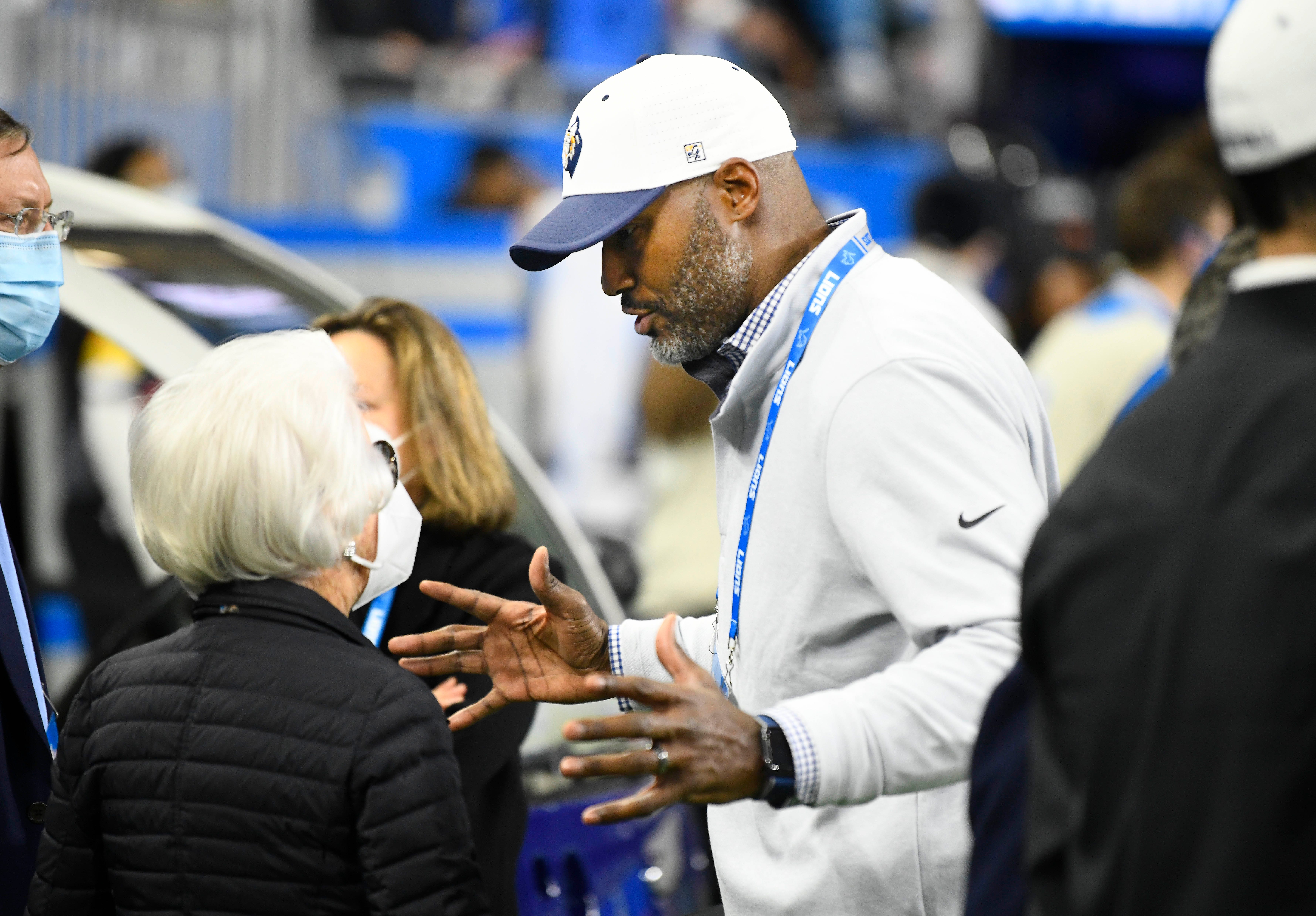 Lions owner Martha Ford talks with Lions Executive Vice President and GM talk during warmups.