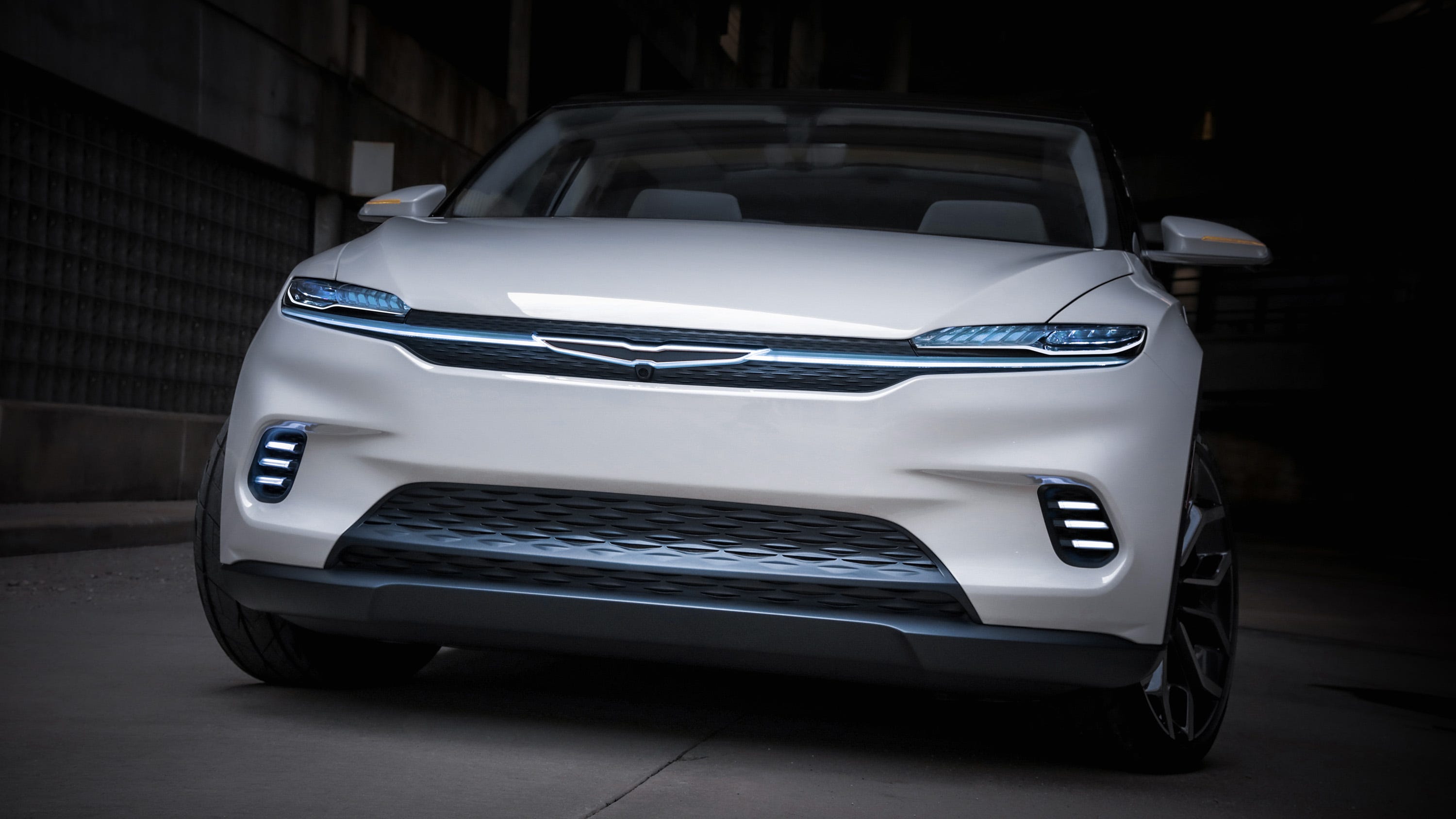 The Chrysler Airflow Concept announces its electric aesthetic with the Chrysler Wing logo tied into a cross-car grille/light blade illuminated with crystal LED lighting.