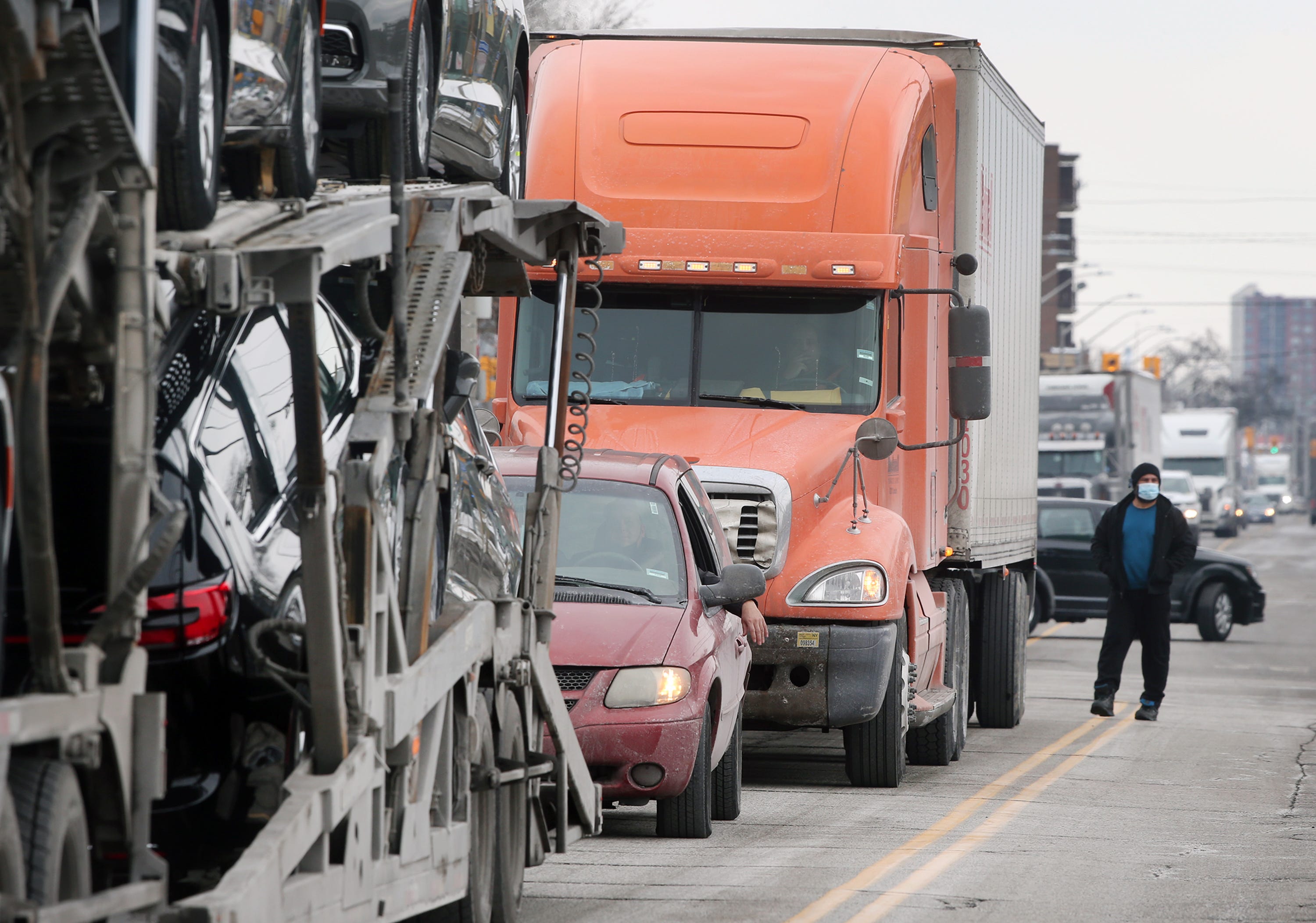 A trucker waits on Wyandotte Street West to cross the Ambassador Bridge, in Windsor, Tuesday, February 8, 2022. Traffic was severely delayed due to protests against vaccine mandates in Canada.