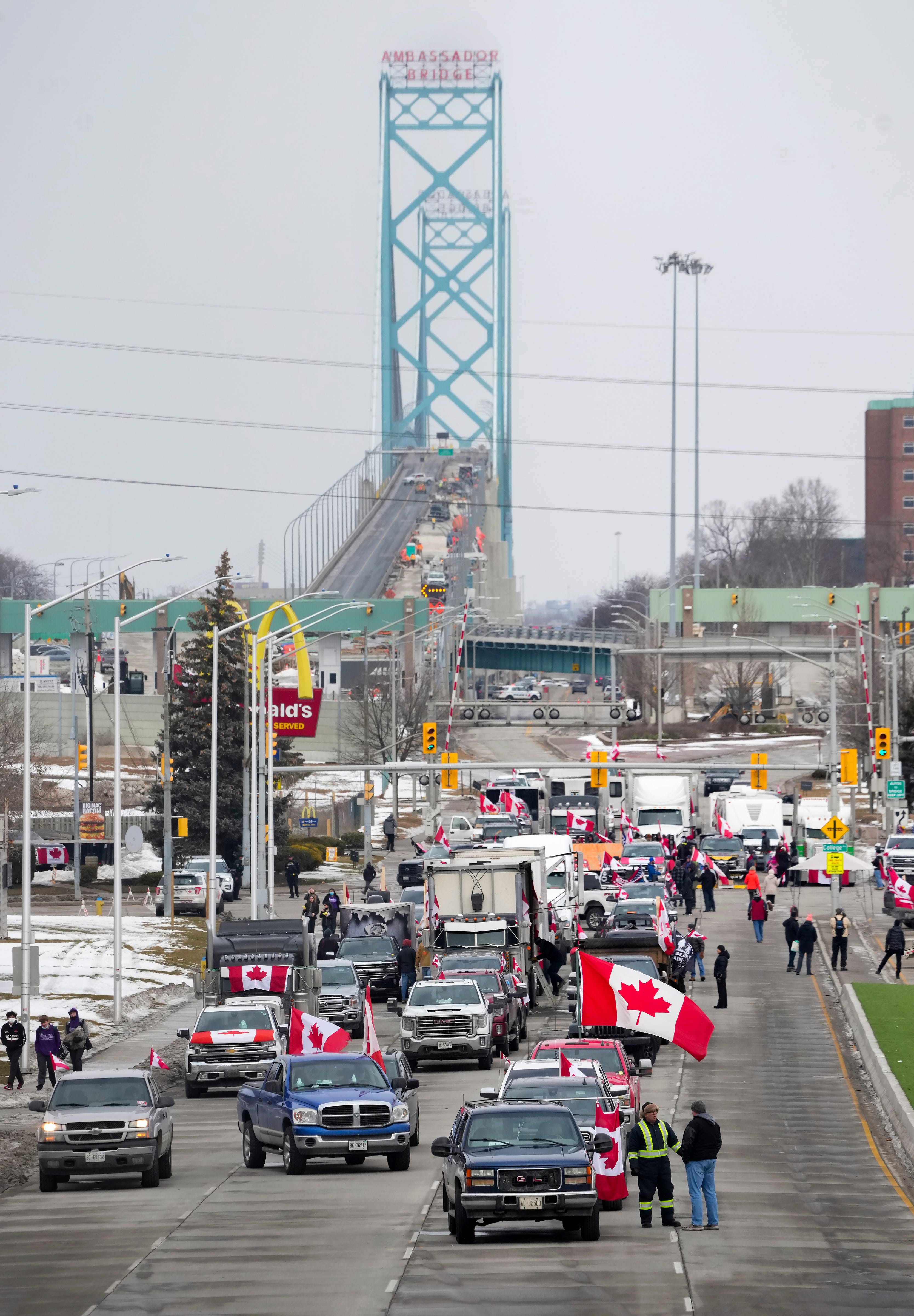 Truckers and supporters block the access leading from the Ambassador Bridge, linking Detroit and Windsor, as truckers and their supporters continue to protest against COVID-19 vaccine mandates and restrictions, in Windsor, Ont., Thursday, Feb. 10, 2022.