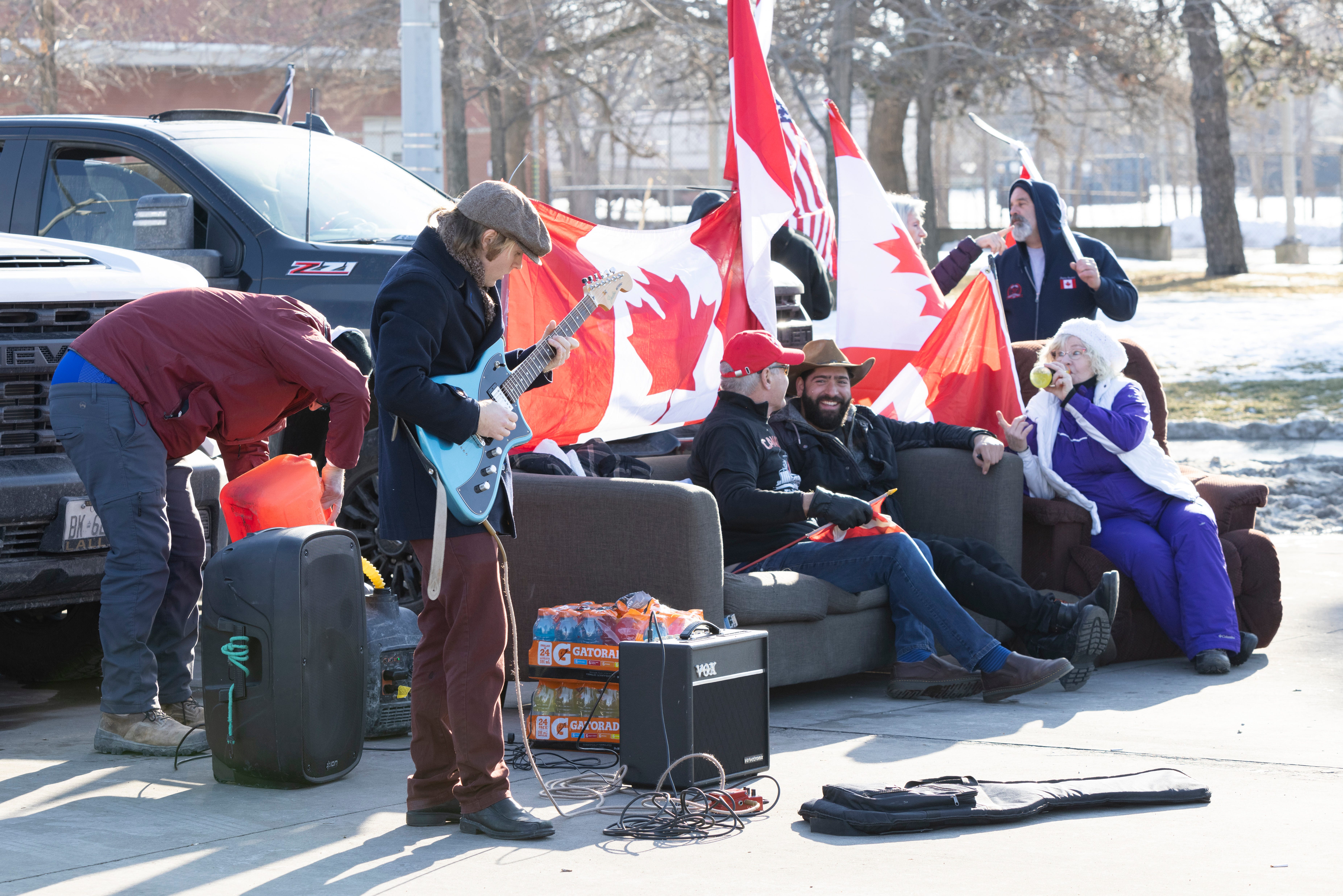 People take part in a protest blocking traffic at the Ambassador Bridge, linking Windsor, Ontario and Detroit on Wednesday, Feb. 9, 2022. The demonstration in solidarity with protests in Ottawa against COVID-19 restrictions has blocked traffic into Canada on the Ambassador Bridge linking Windsor and Detroit since Monday and is the the single busiest commercial crossing in North America.