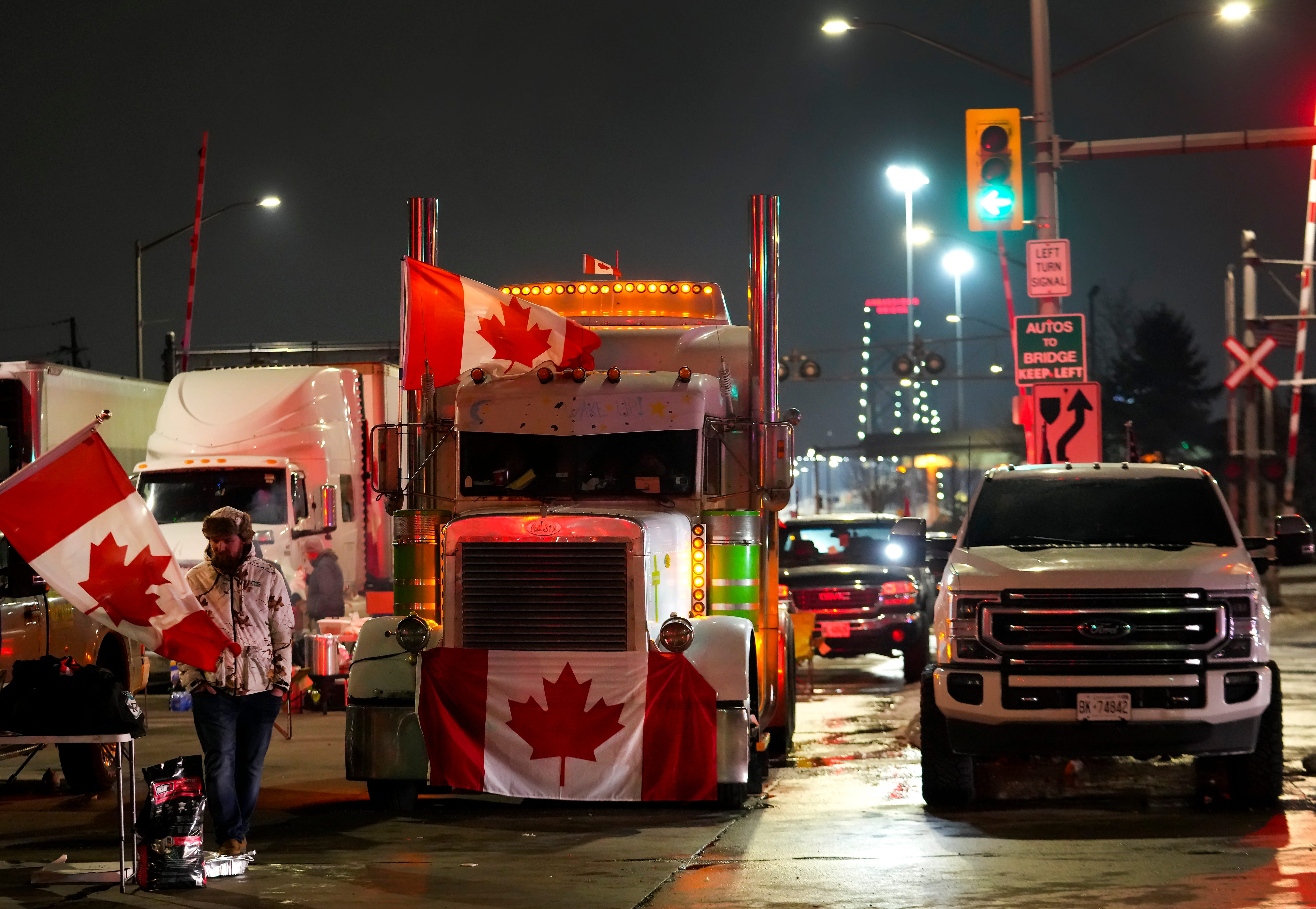 Truckers and supporters block the access leading from the Ambassador Bridge, linking Detroit and Windsor, as truckers and their supporters continue to protest against the COVID-19 vaccine mandates and restrictions in Windsor, Ontario, on Wednesday, Feb. 9, 2022.