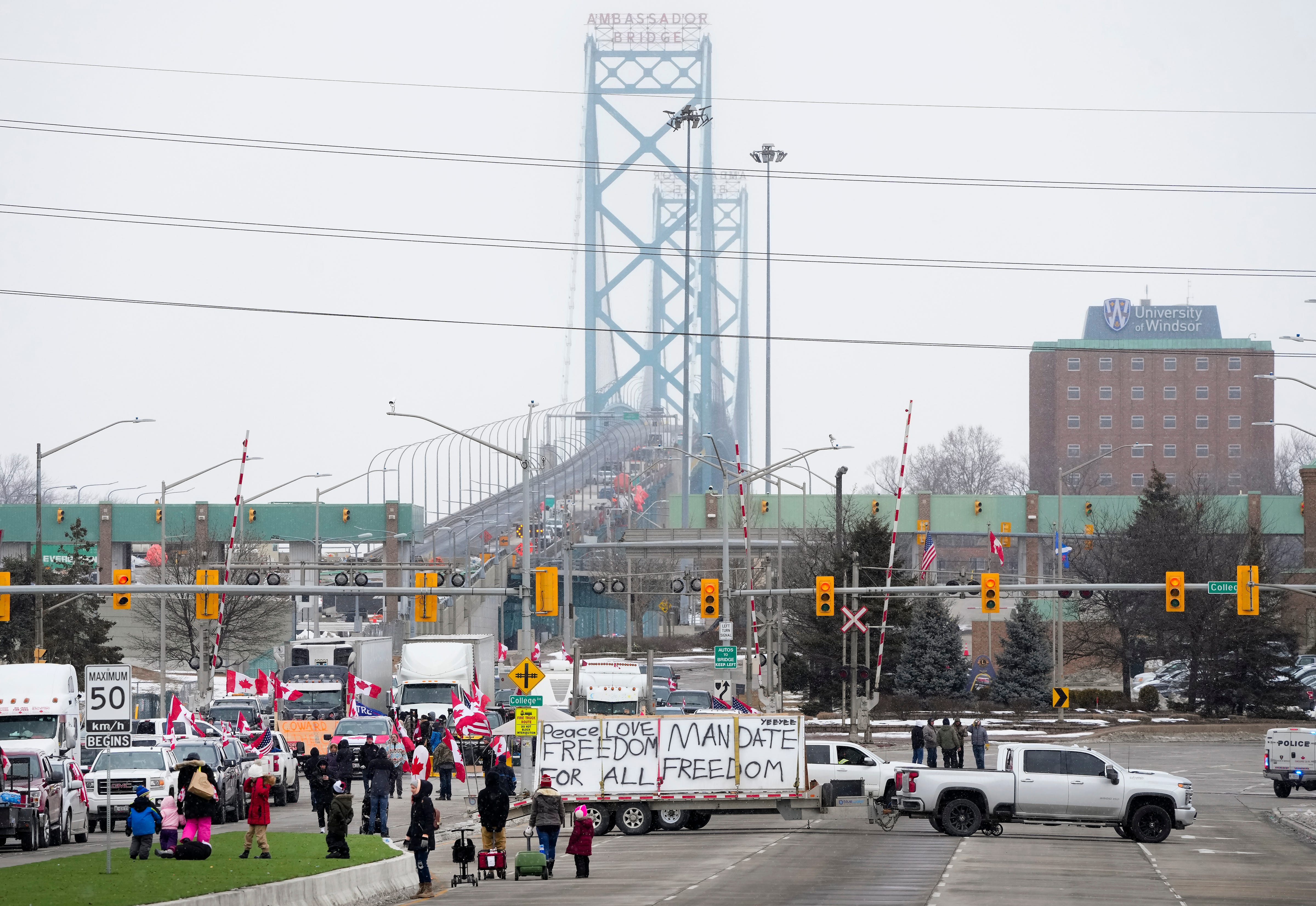 Truckers and supporters block the access leading from the Ambassador Bridge, linking Detroit and Windsor, as truckers and their supporters continue to protest against COVID-19 vaccine mandates and restrictions, in Windsor, Ont., Thursday, Feb. 10, 2022.