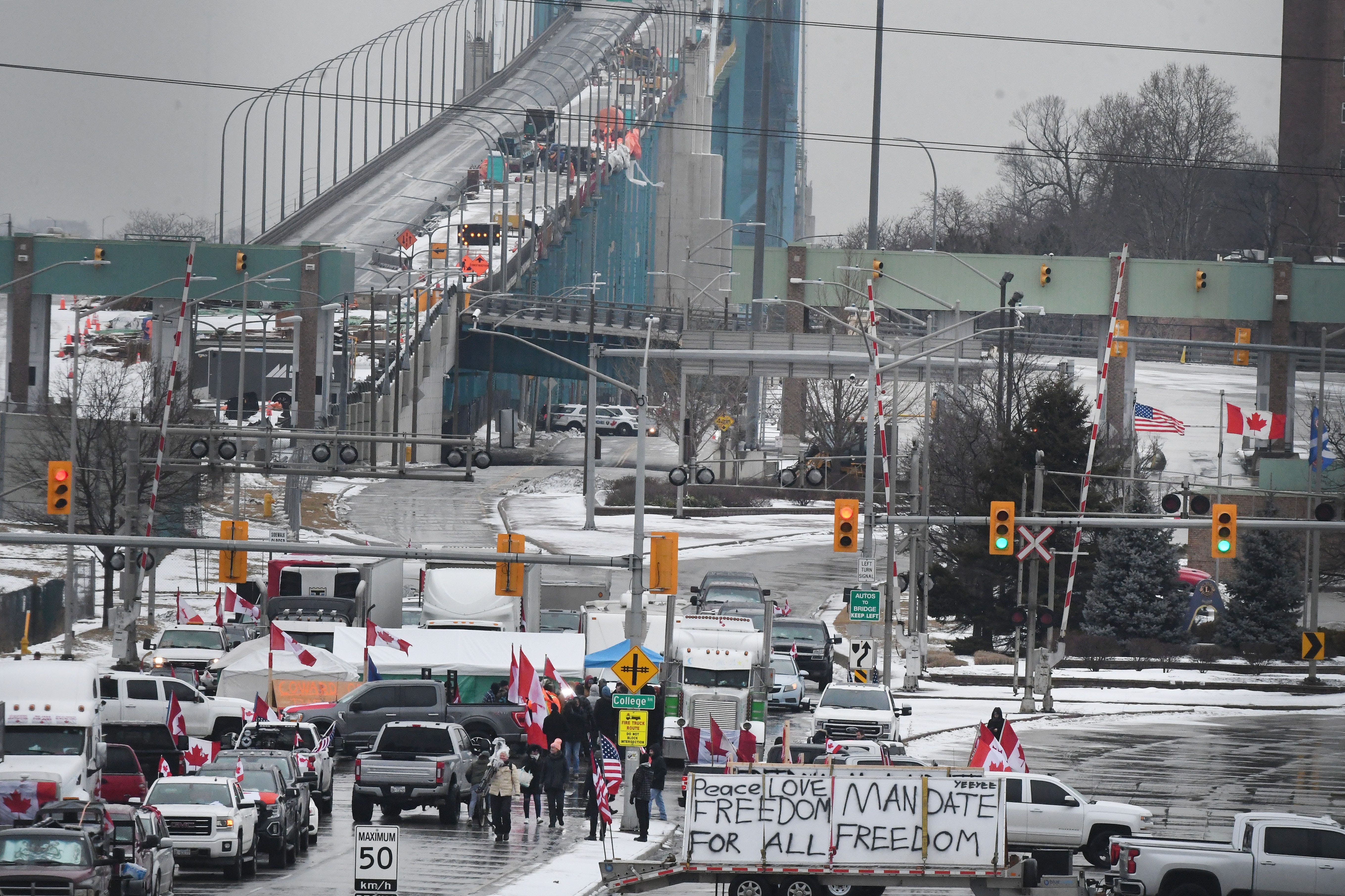 Canadian truckers protest on corner of Huron Church Road and Tecumseh, with the Ambassador Bridge in the background, in Windsor, Canada on February 11, 2022.