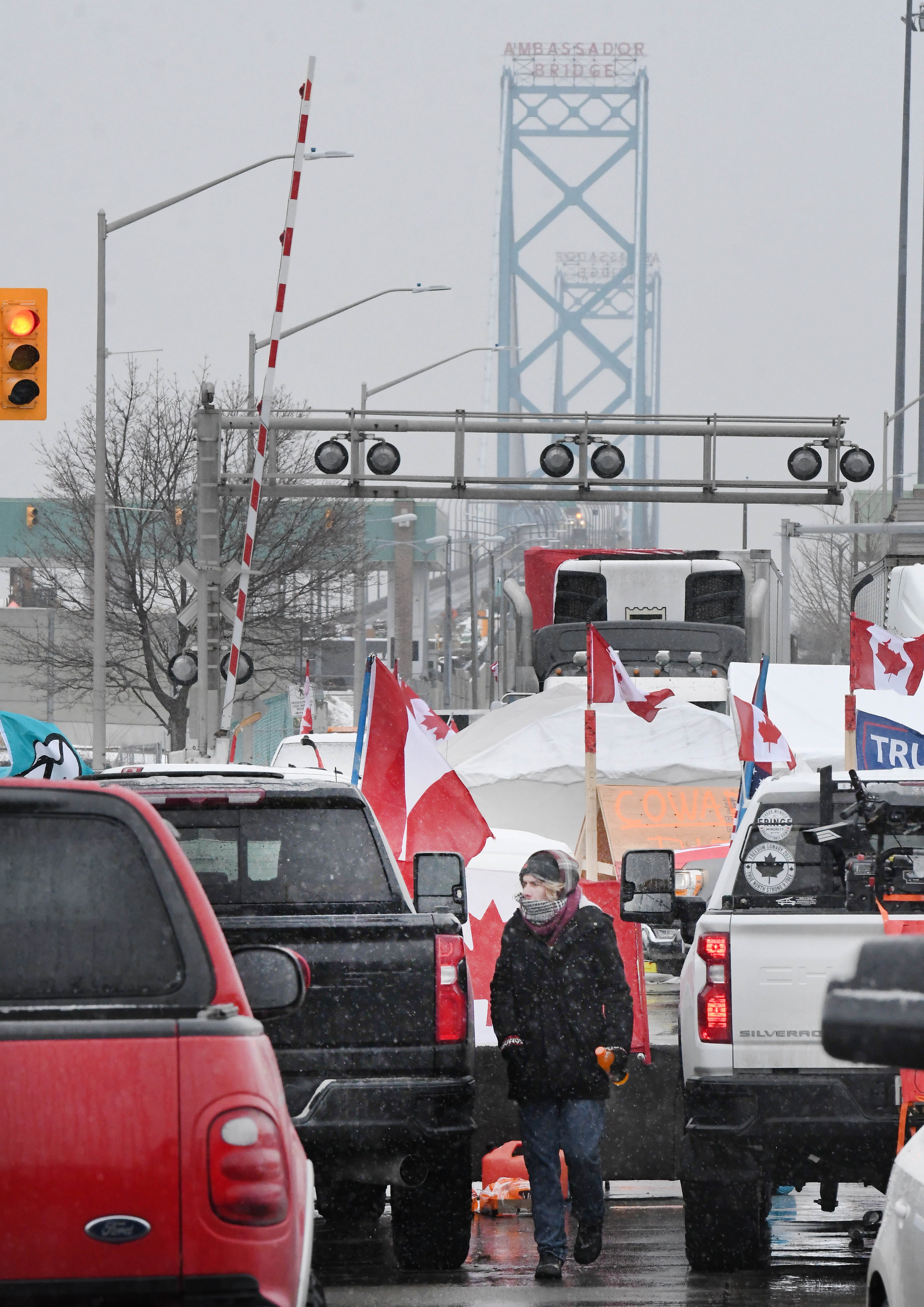 Canadian truckers protests against COVID measures on corner of Huron Church Road and Tecumseh, with the Ambassador Bridge in the background, in Windsor, Canada on February 11, 2022.
