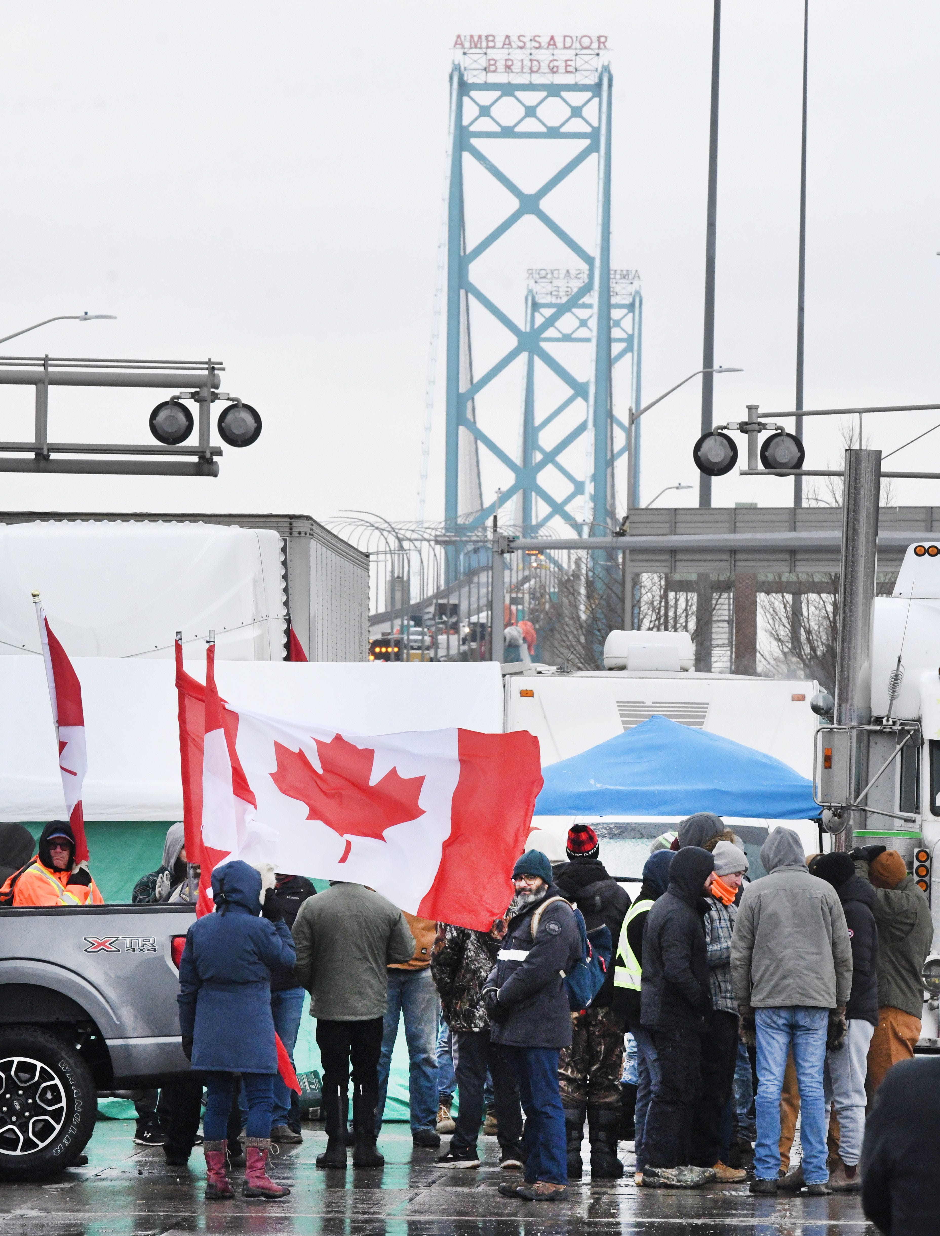 Canadian truckers protests against COVID measures on corner of Huron Church Road and Tecumseh, with the Ambassador Bridge in the background, in Windsor, Canada on February 11, 2022.