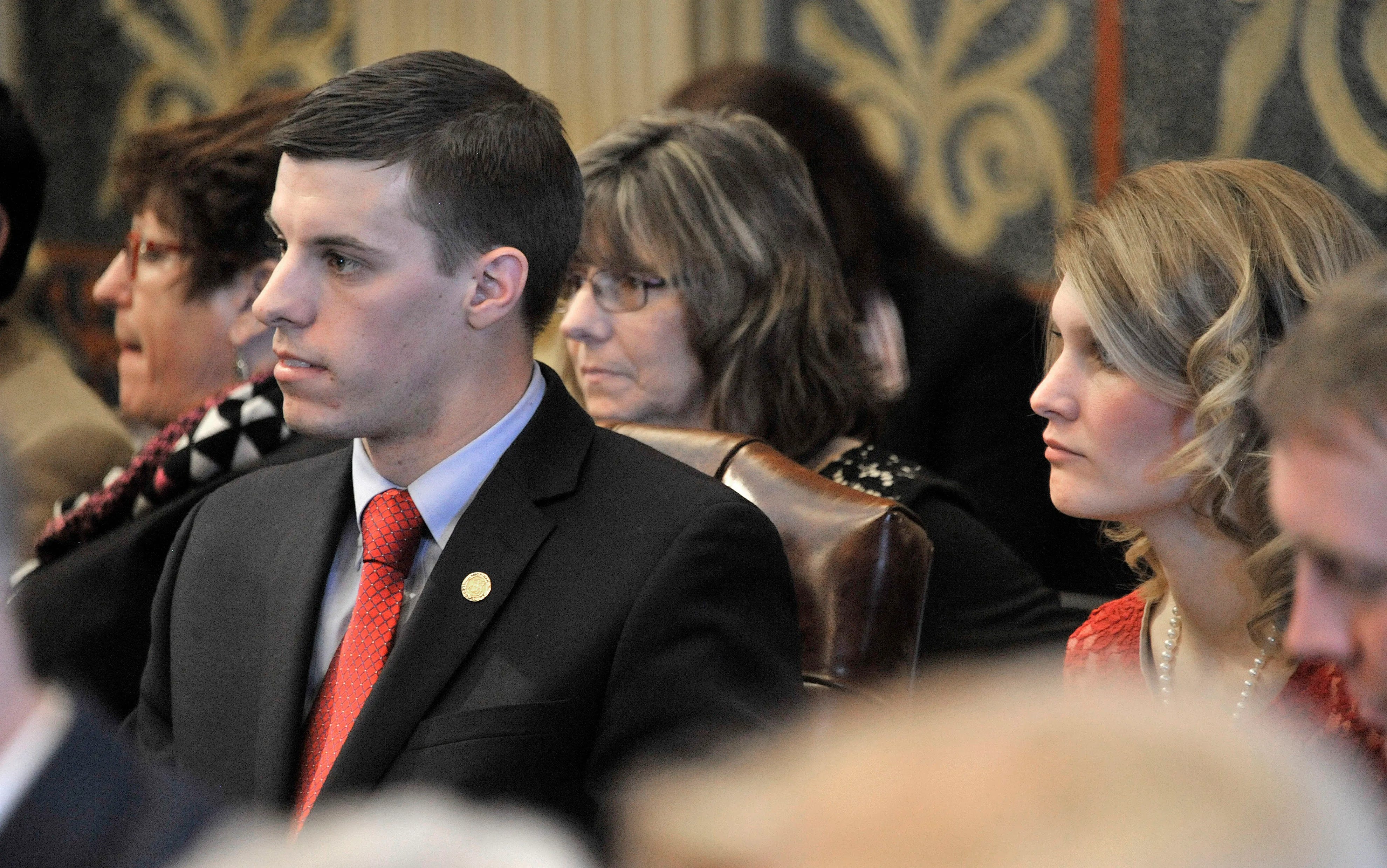 Then-state Rep. Lee Chatfield, R-Levering, sits with his wife, Stephanie, far right, after taking his oath of office in 2015.