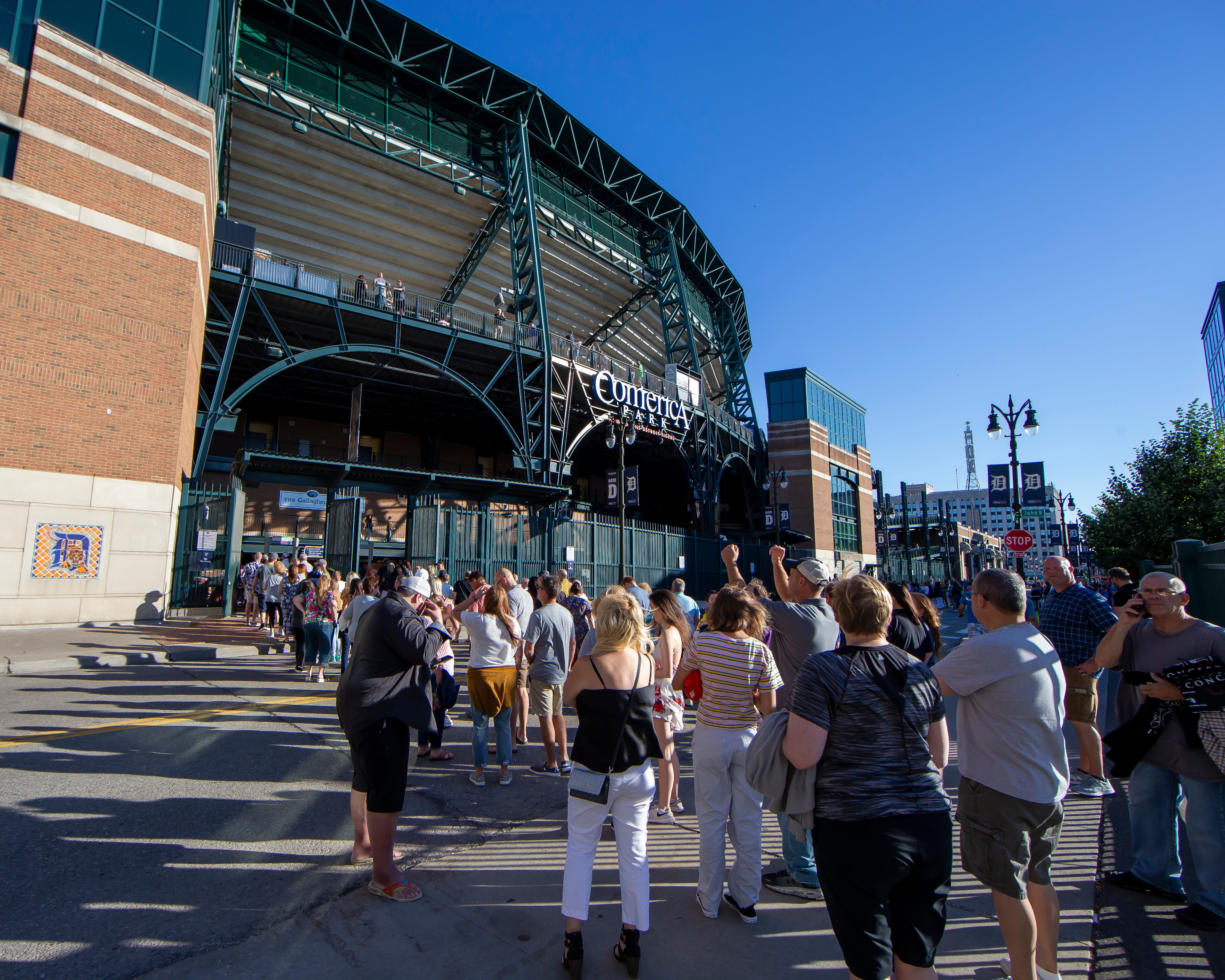 Fans wait in line to attend the Billy Joel concert at Comerica Park.