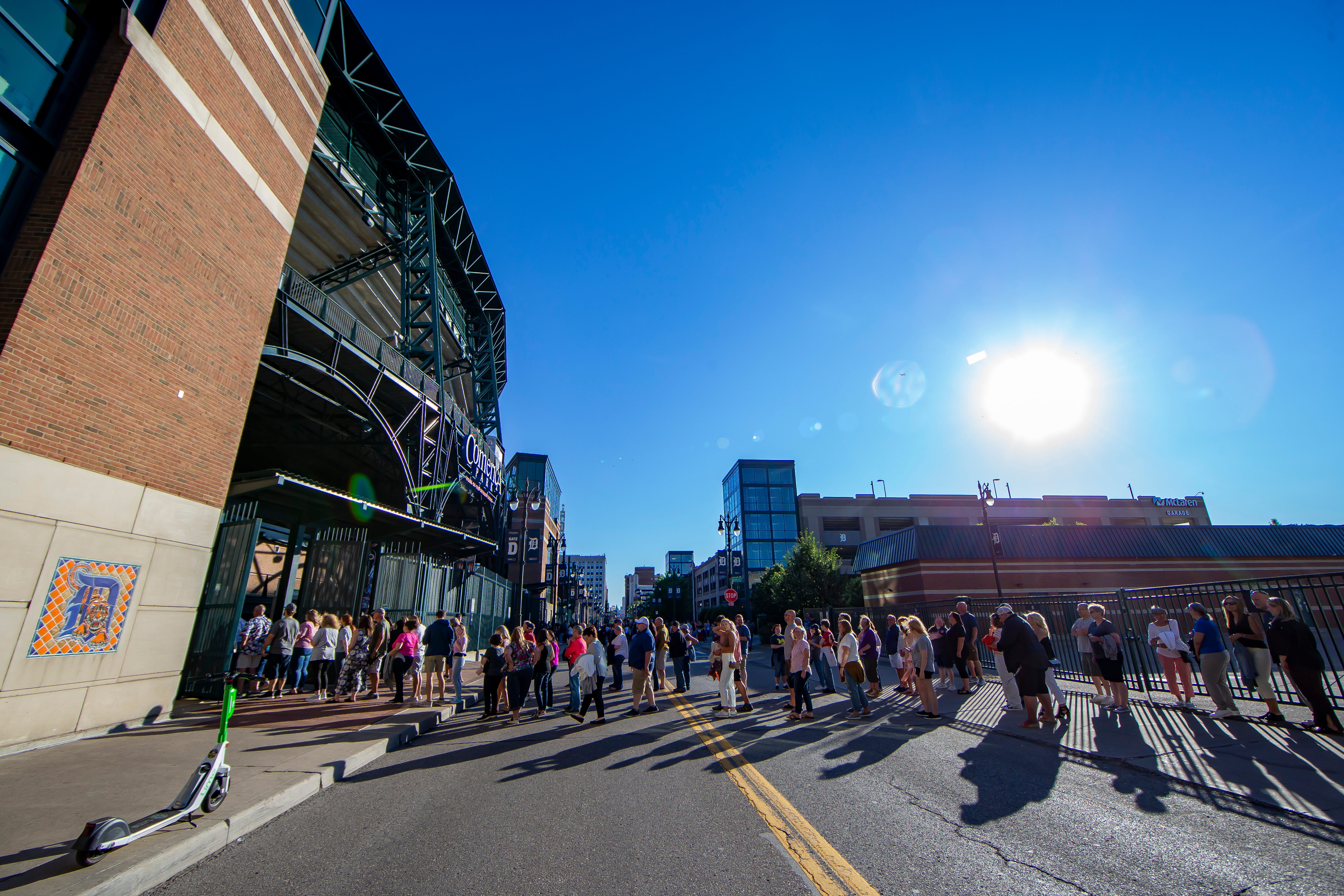 Fans wait in line to attend the Billy Joel concert at Comerica Park in Detroit.