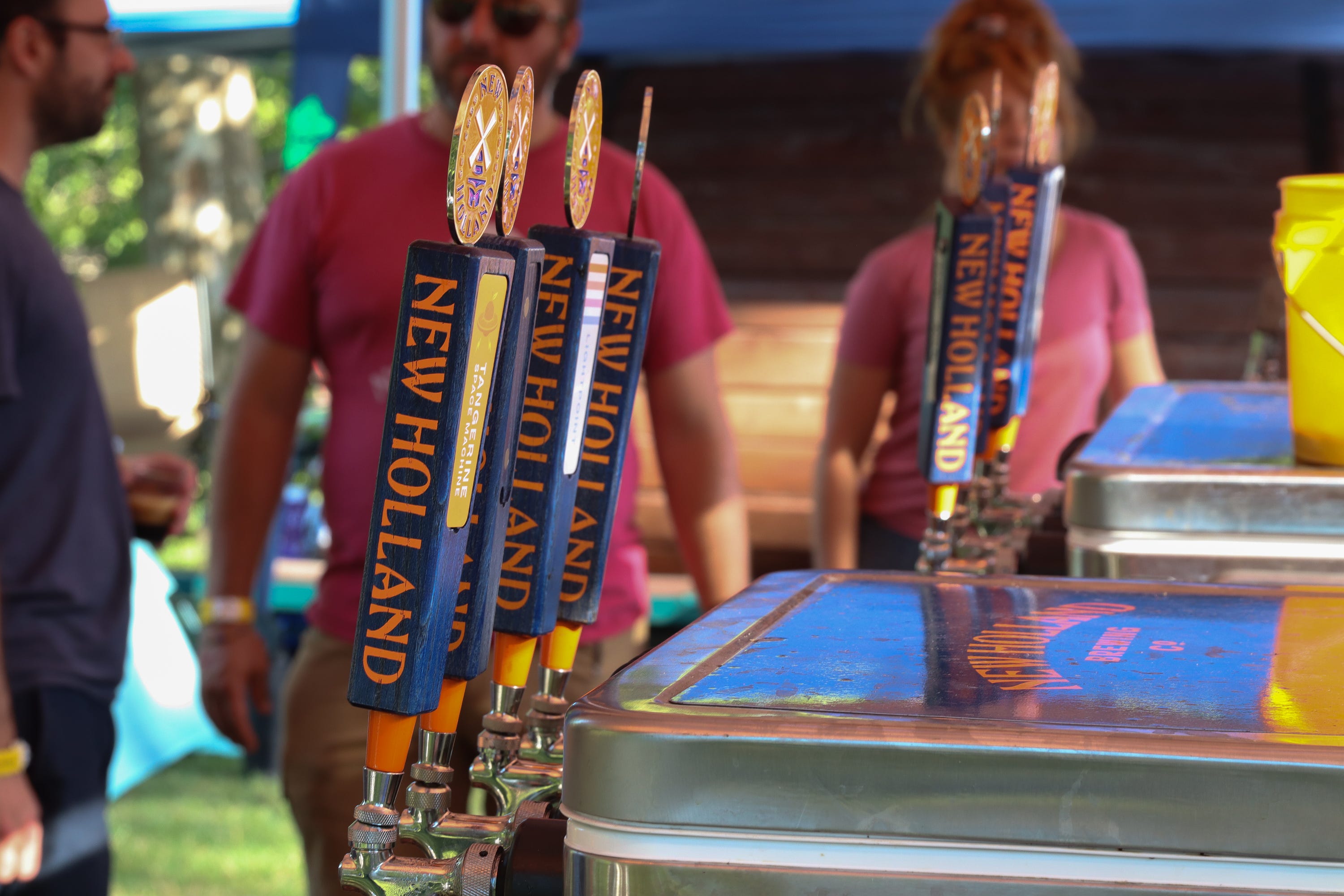 Tap handles are shown at the New Holland Brewing Co. stand at the Michigan Brewers Guild Summer Beer Festival at Riverside Park in Ypsilanti on Friday, July 22, 2022.