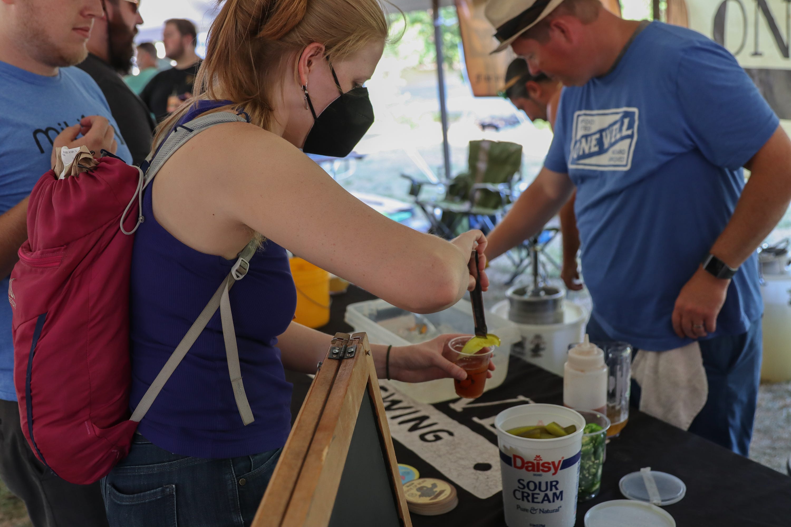 Anna Goren, of Ypsilanti, puts a pickle into her "bloody" Xalapa Blonde Ale from Kalamazoo's One Well Brewing. The drink blends a peppery, but not hot, jalapeno ale with bloody mary mix and fixings for a different take on a beer.