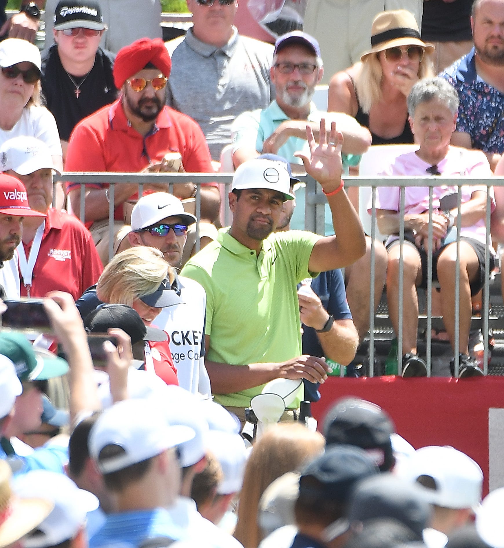 Tony Finau waves to the crowd as he makes his way to the first tee before winning the 2022 Rocket Mortgage Classic in Detroit.